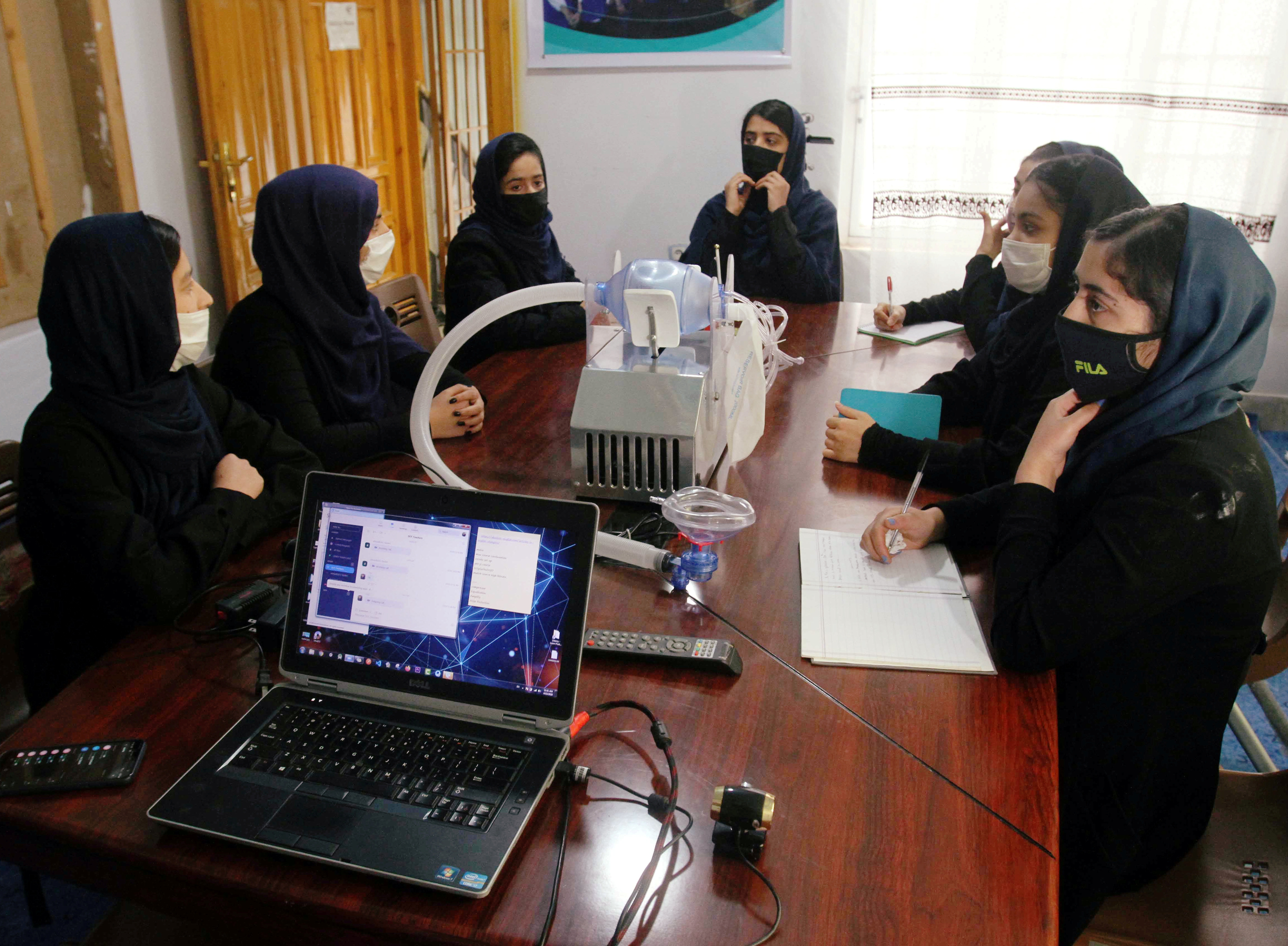 Members of an Afghan all-female robotics team work on an open-source and low-cost ventilator in Herat