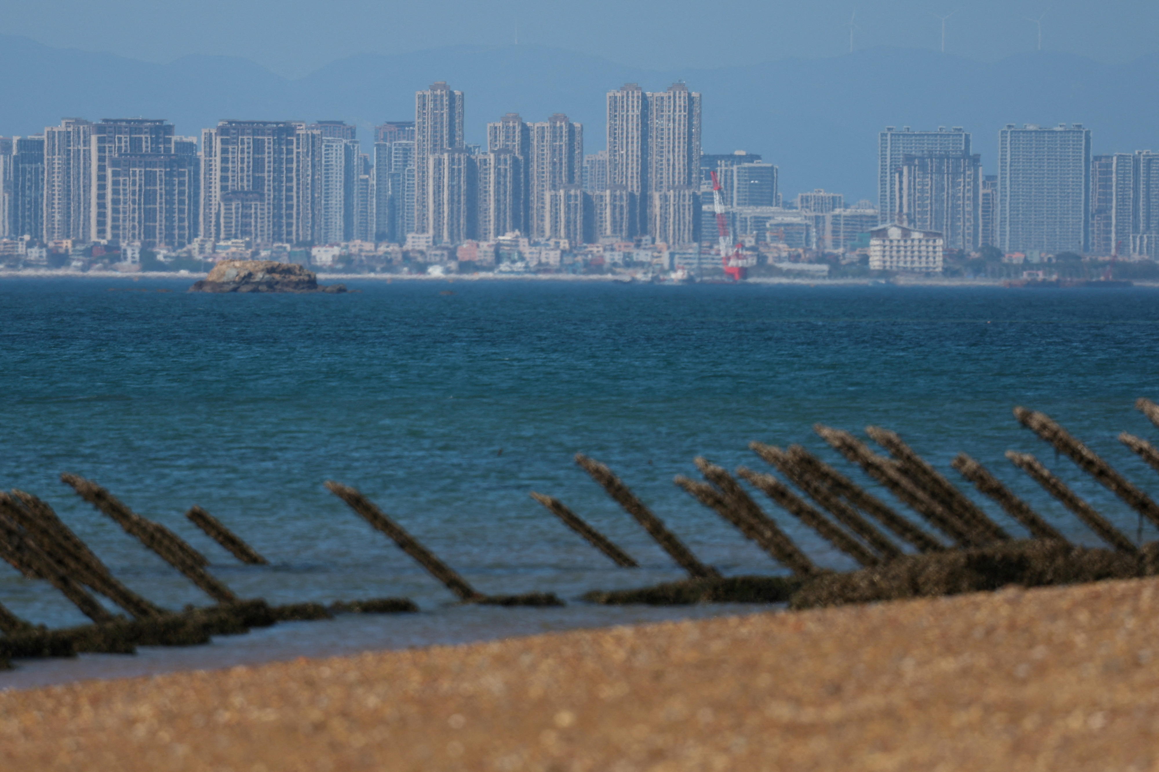 Anti-landing barricades are pictured on the beach, with China's Xiamen city in the background, in Kinmen