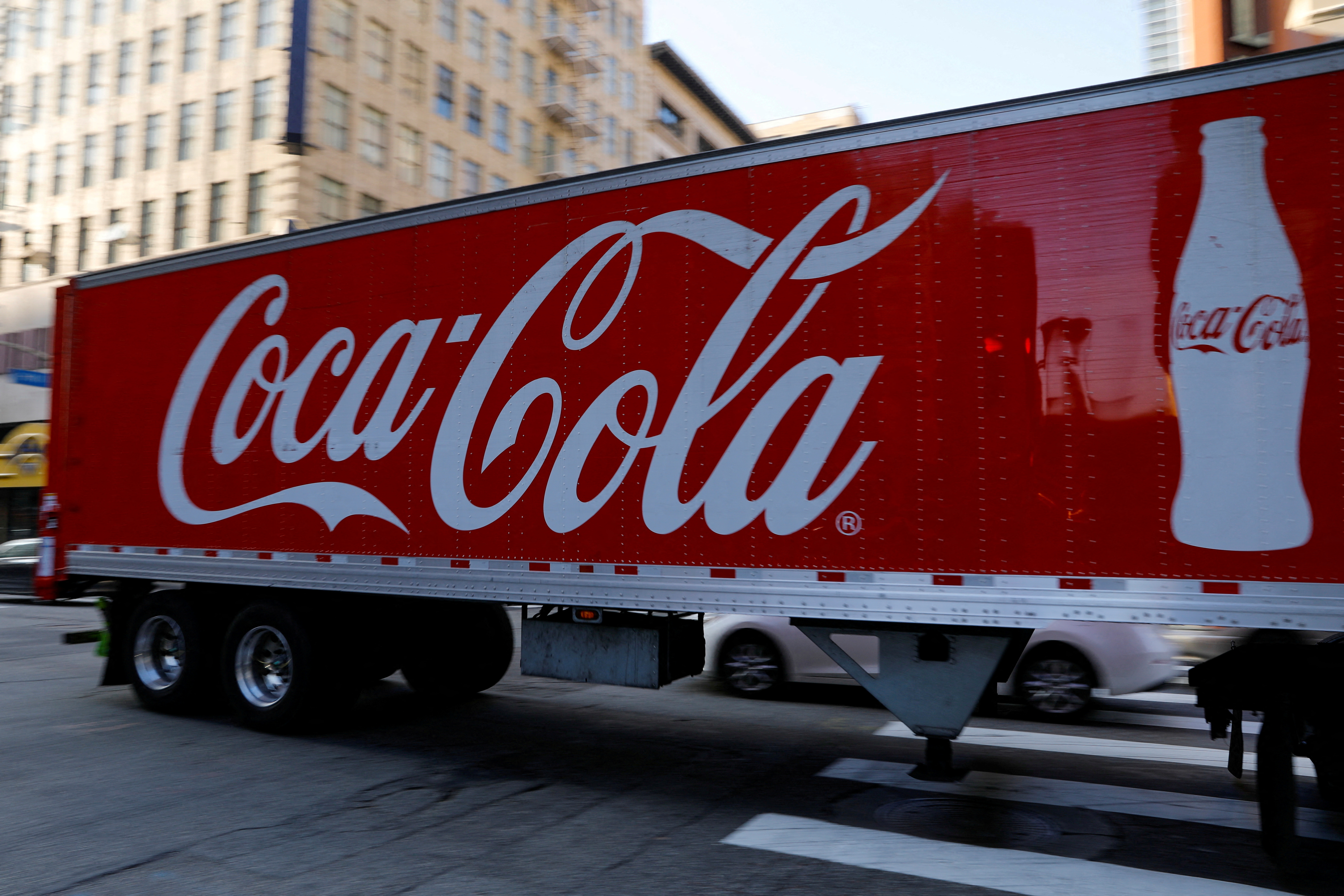 A Coca-Cola truck makes its way through downtown Los Angeles