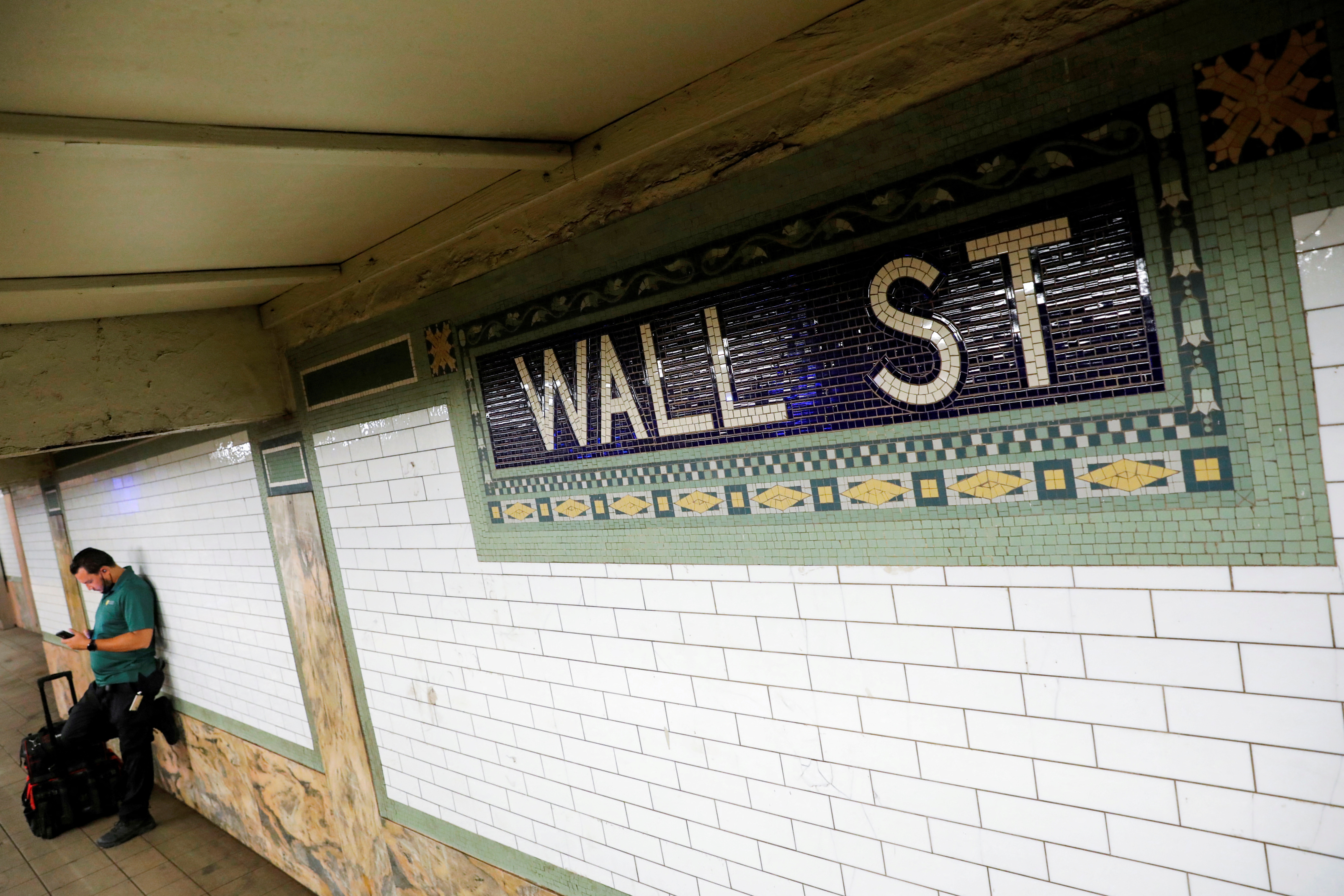 A person waits on the Wall Street subway platform in the Financial District of Manhattan, New York City