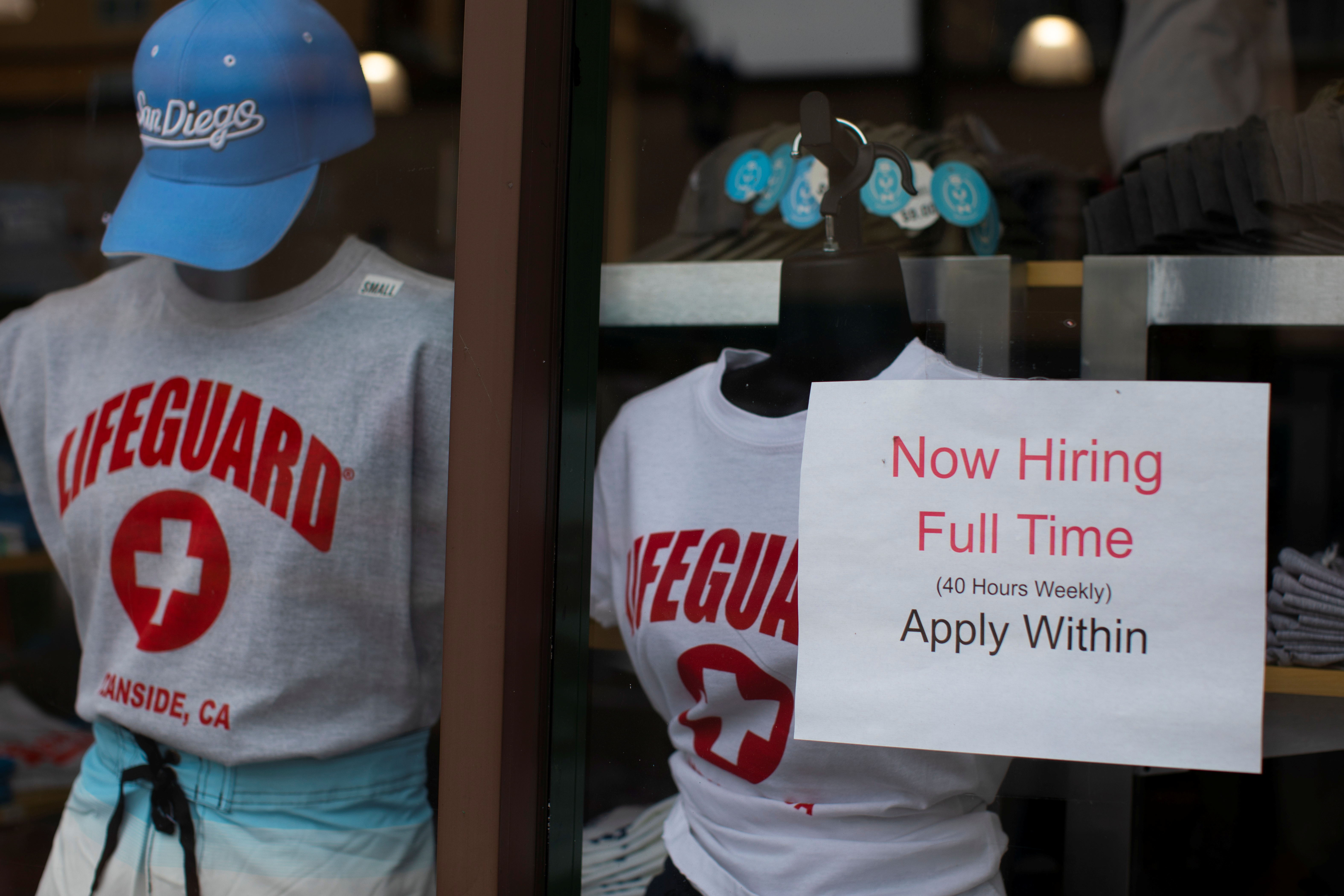 A clothing store advertises a full time job on its shop window in Oceanside, California
