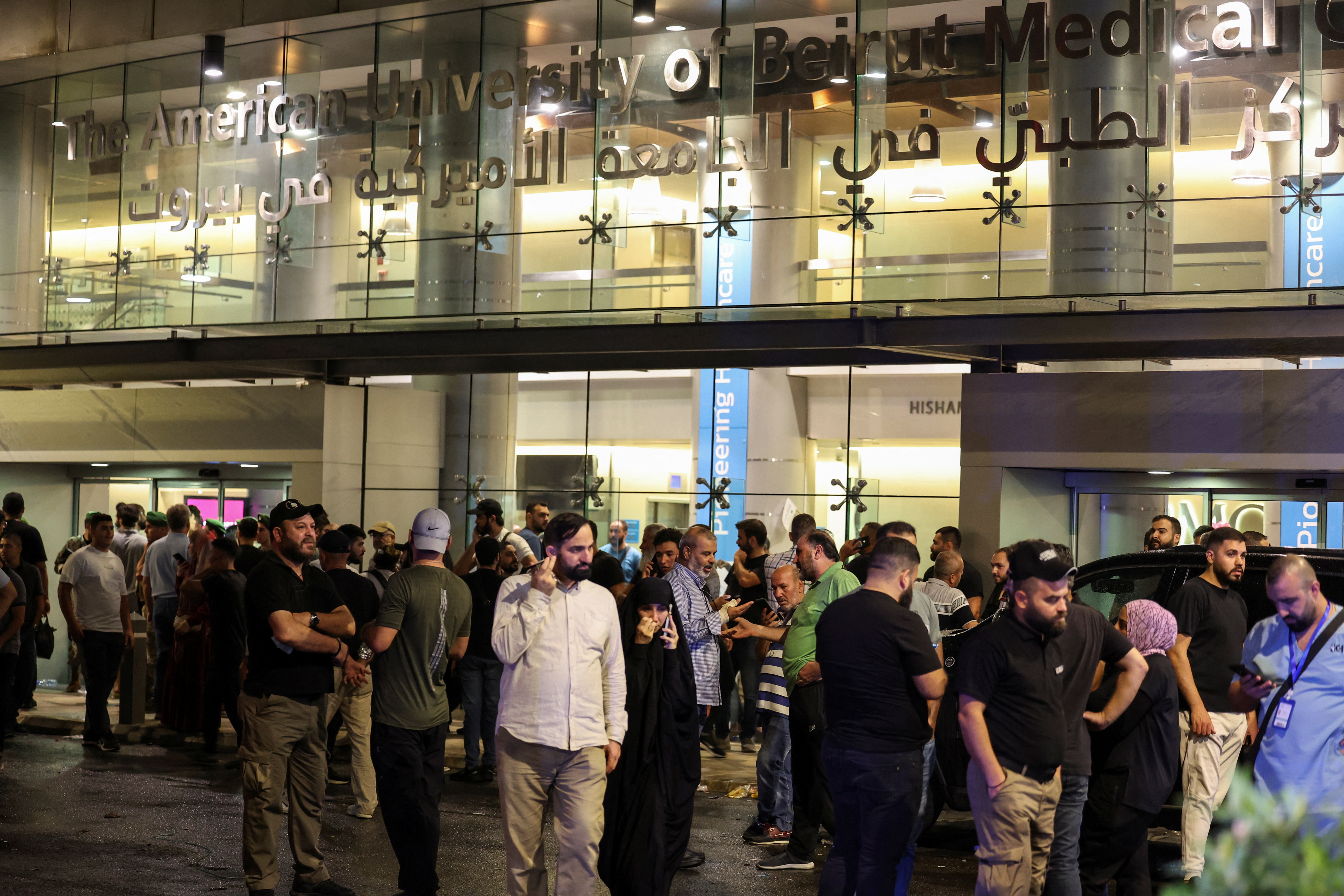 People gather outside American University of Beirut Medical Center (AUBMC) as people, including Hezbollah fighters and medics, were wounded when the pagers they use to communicate exploded across Lebanon, according to a security source, in Beirut