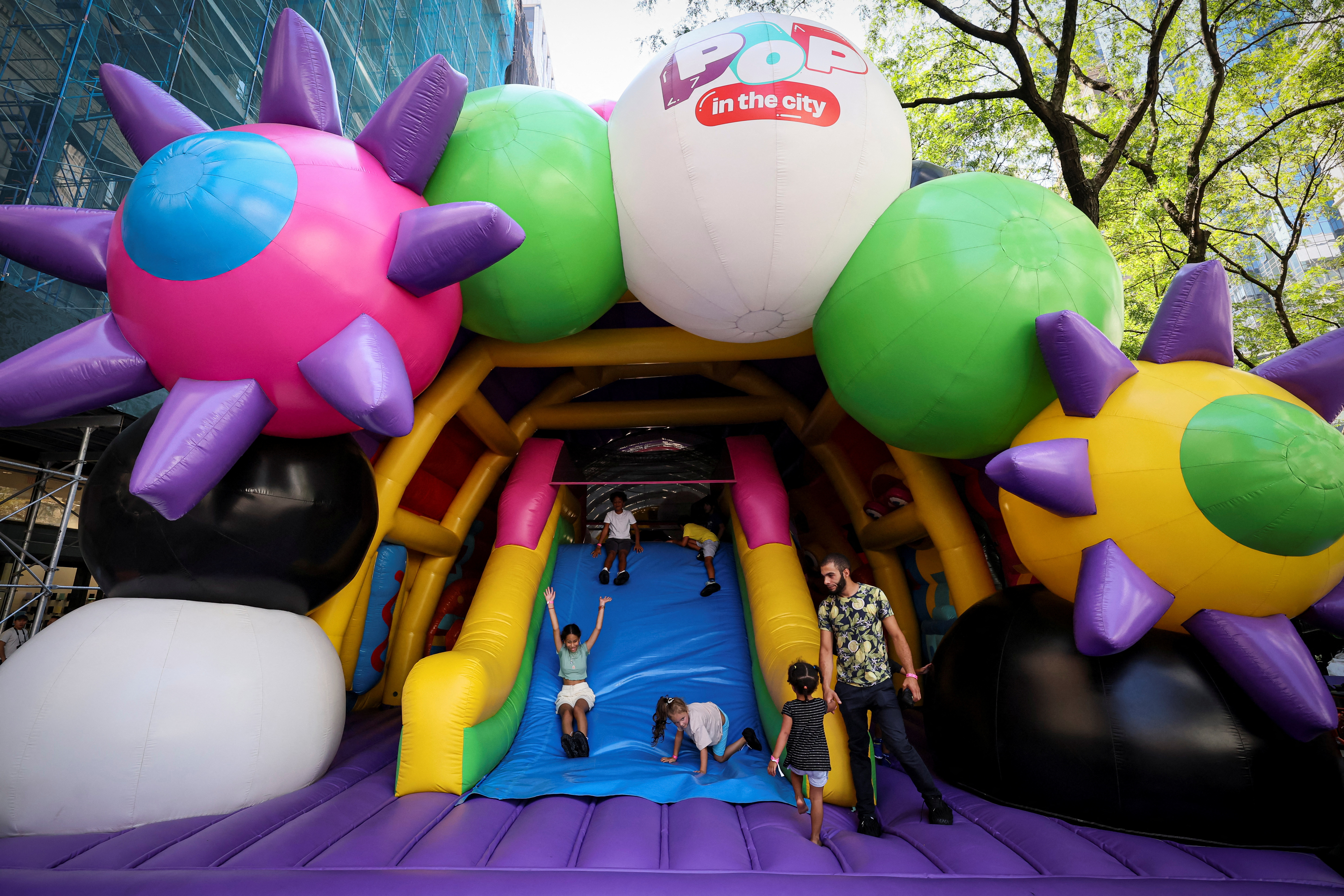 Children enjoy Pop in the City, a 120-foot-long inflatable walk-through experience in New York