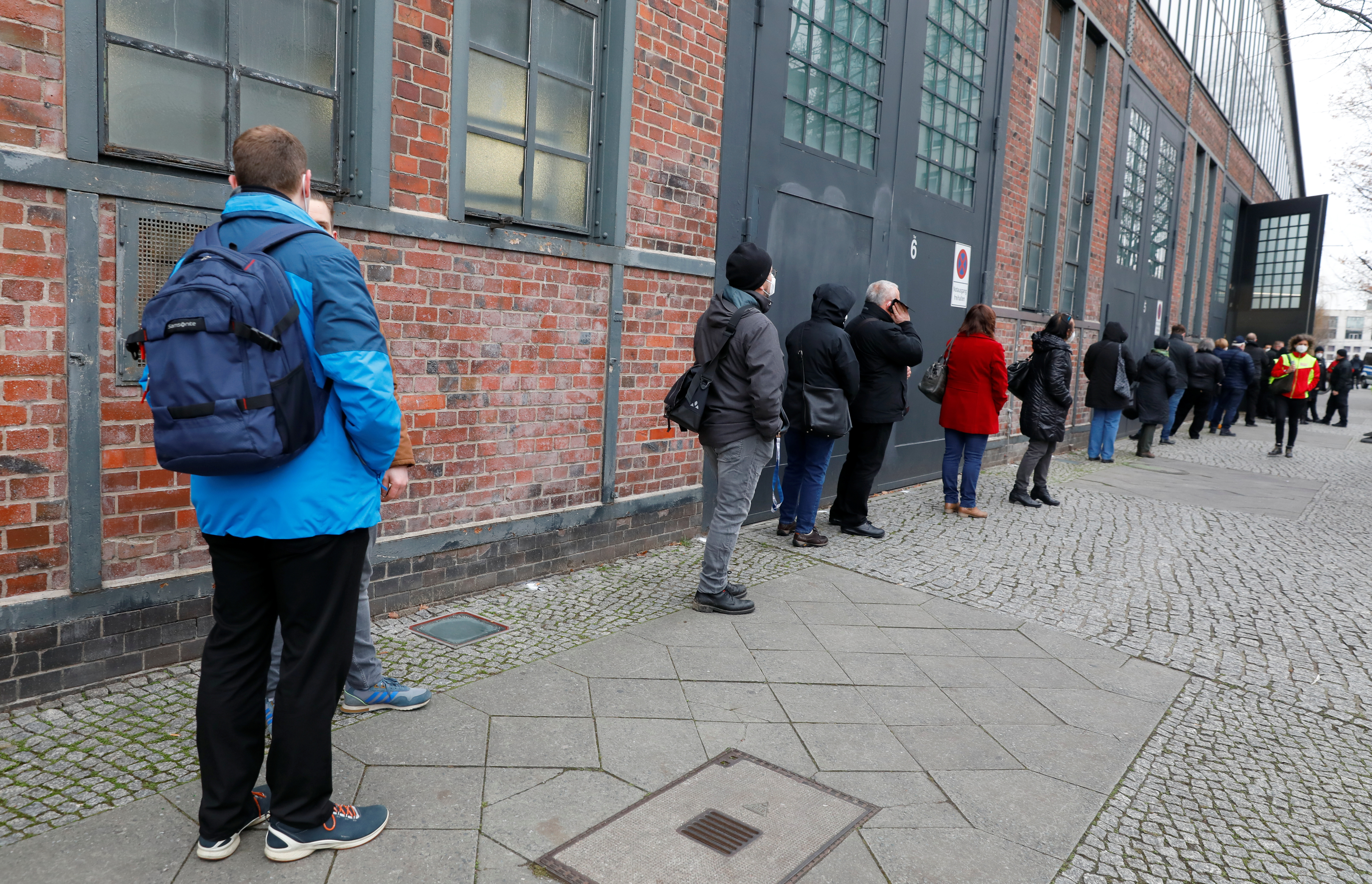 People queue to be vaccinated by the Pfizer-BioNTech COVID-19 vaccine at a coronavirus disease (COVID-19) vaccination centre in Berlin, Germany, December 26, 2020. REUTERS/Michele Tantussi