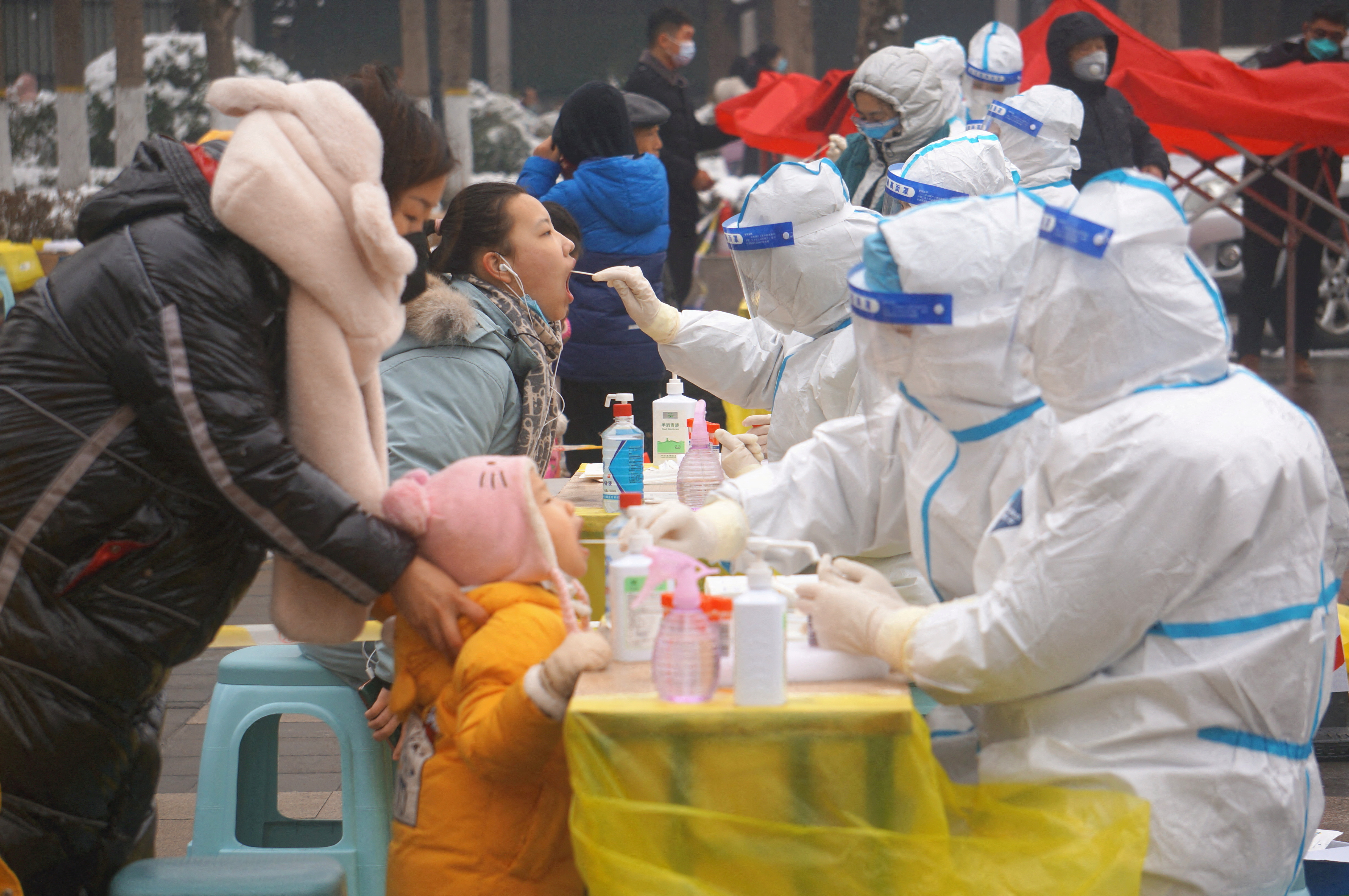Medical workers collect swabs from residents during a citywide nucleic acid testing in Zhengzhou