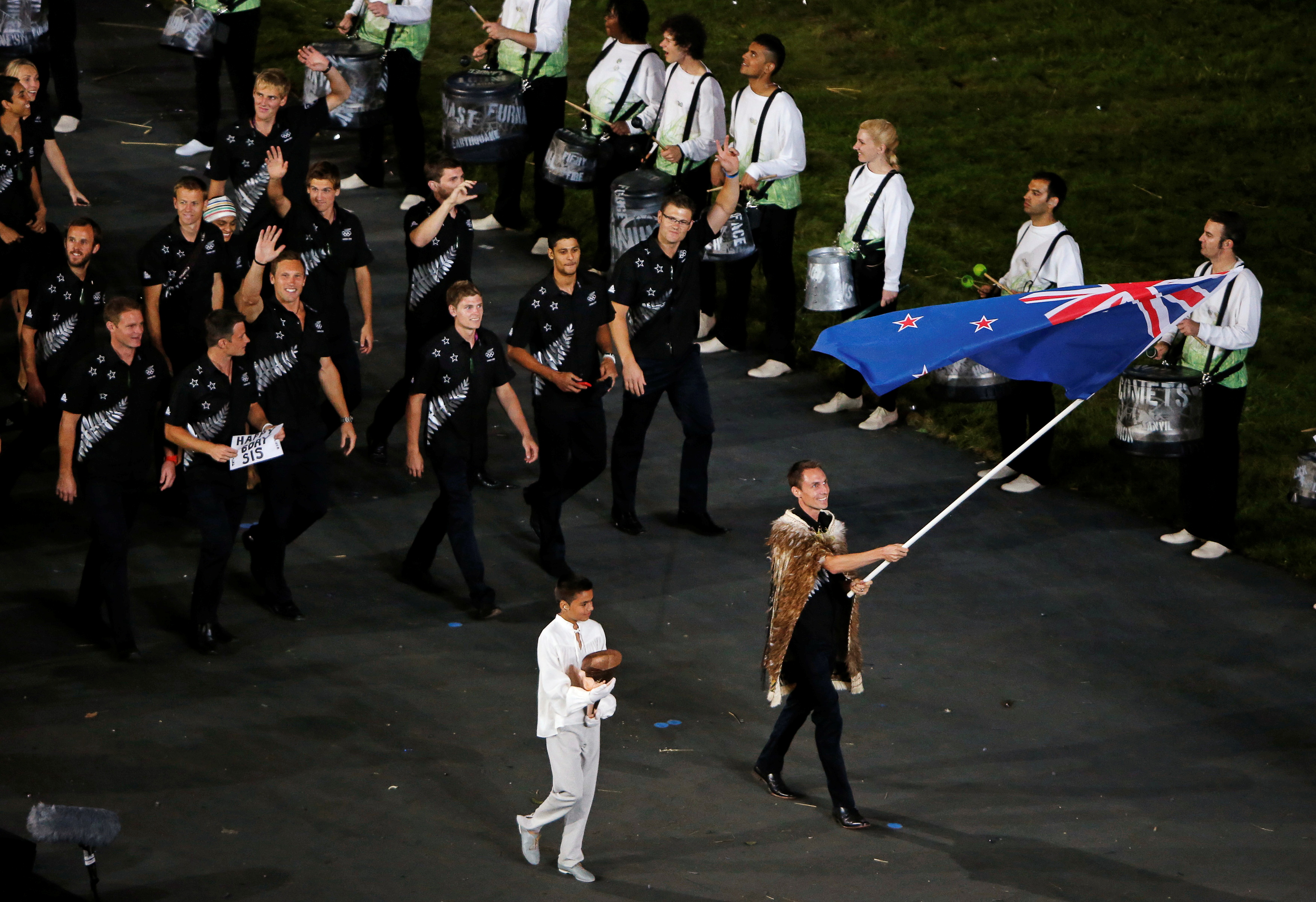 New Zealand's flag bearer Nick Willis holds the national flag as he leads the contingent in the athletes parade during the opening ceremony of the London 2012 Olympic Games at the Olympic Stadium