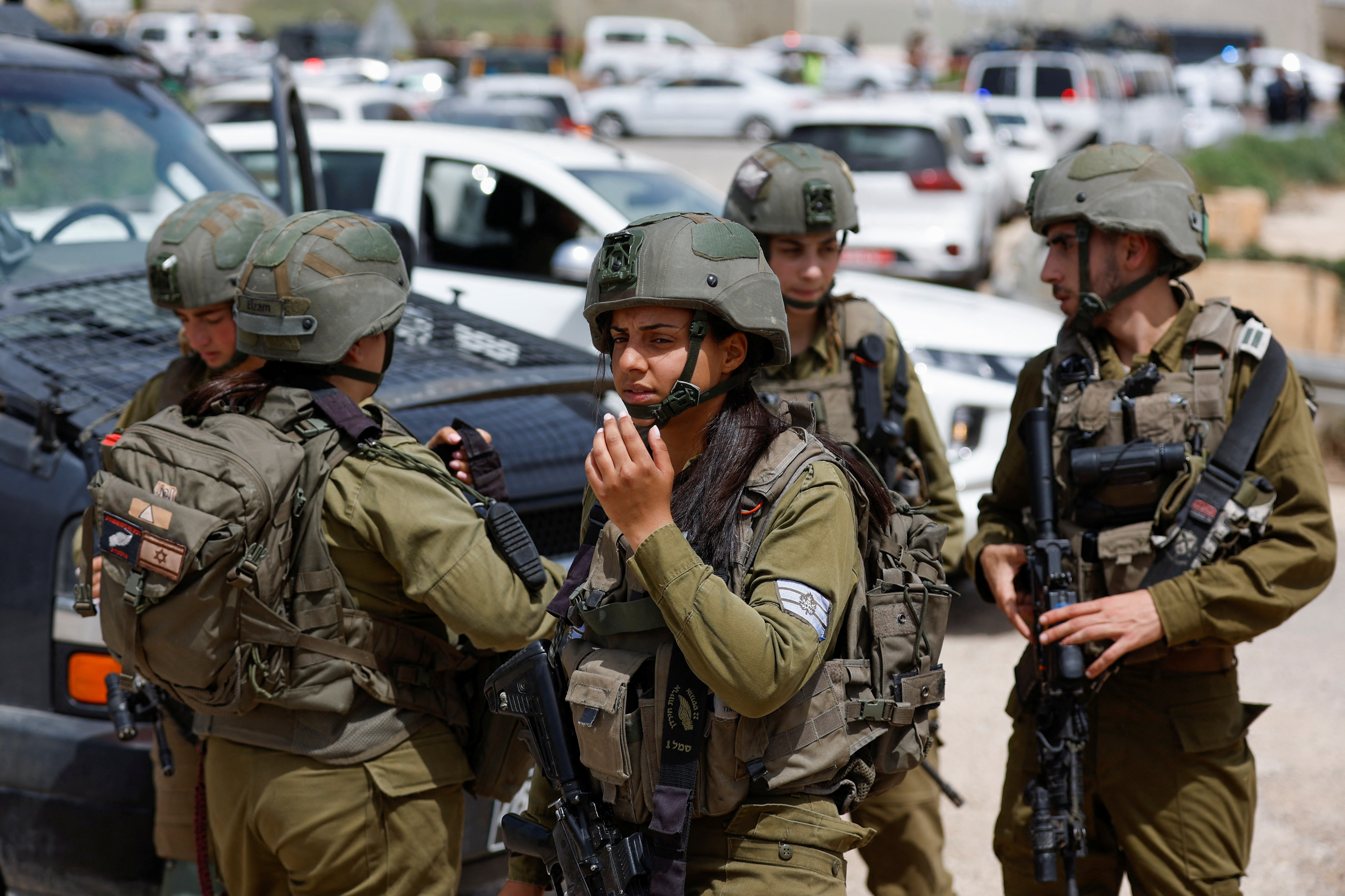 Israeli troops stand guard at a shooting attack scene in the Jordan Valley, in the Israeli-occupied West Bank