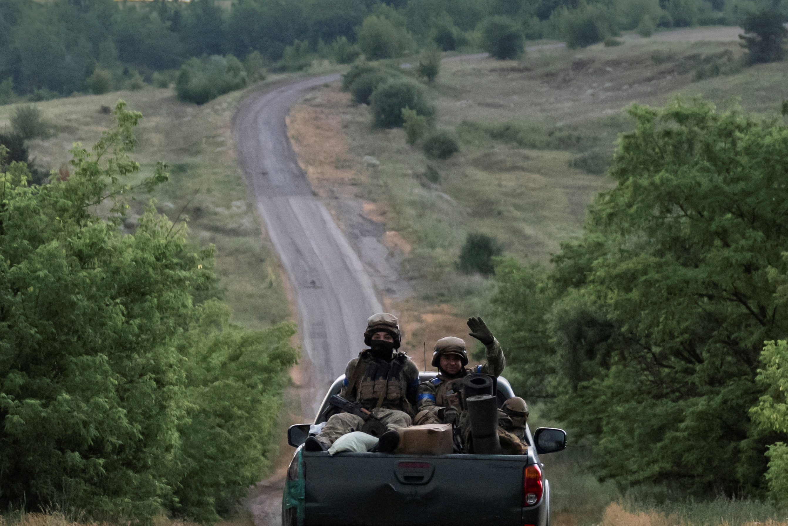 Ukrainian servicemen ride pickup truck near the front line near the town of Vovchansk