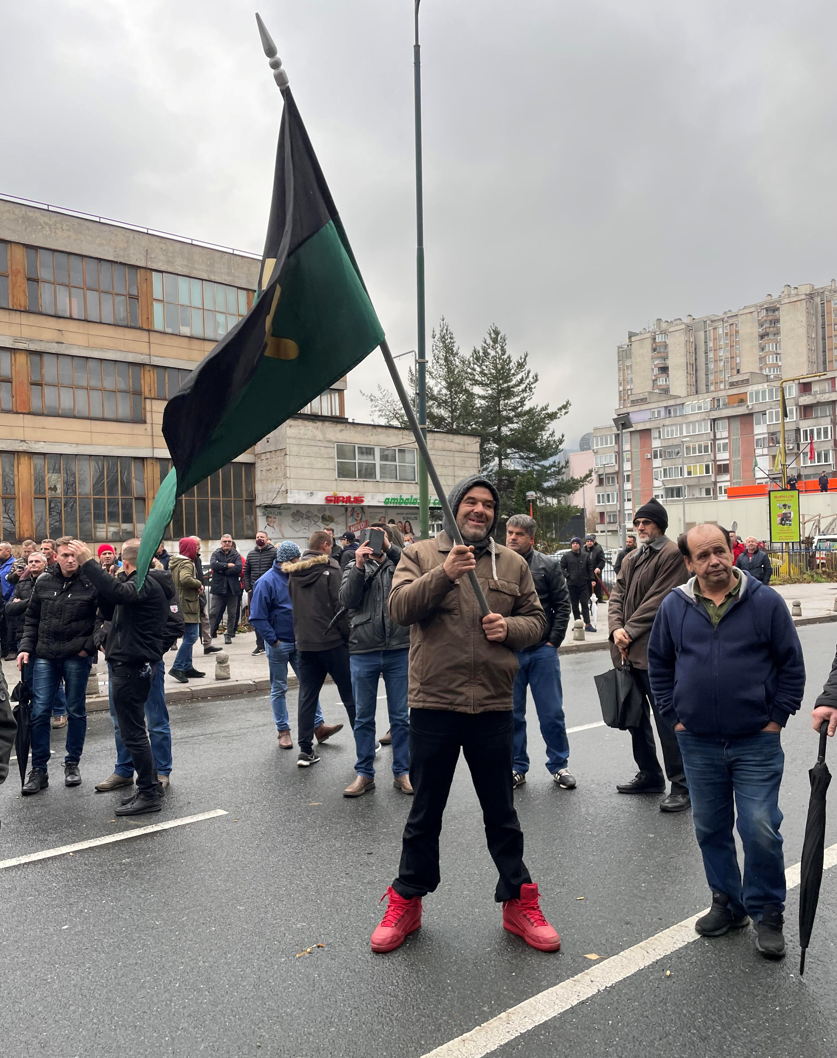 Coal miner holds flag during protest in Sarajevo