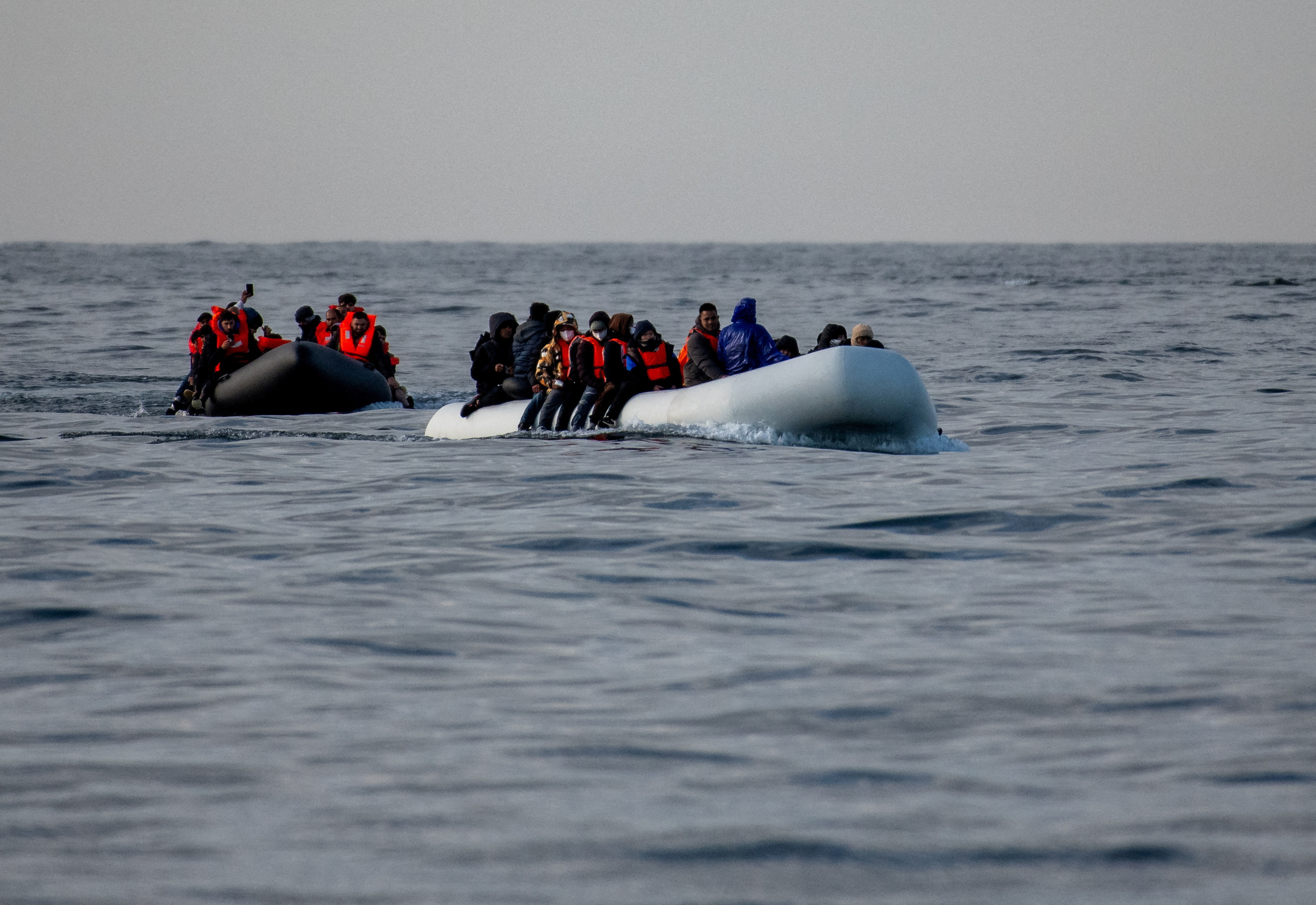 Migrants cross the English Channel in small boats