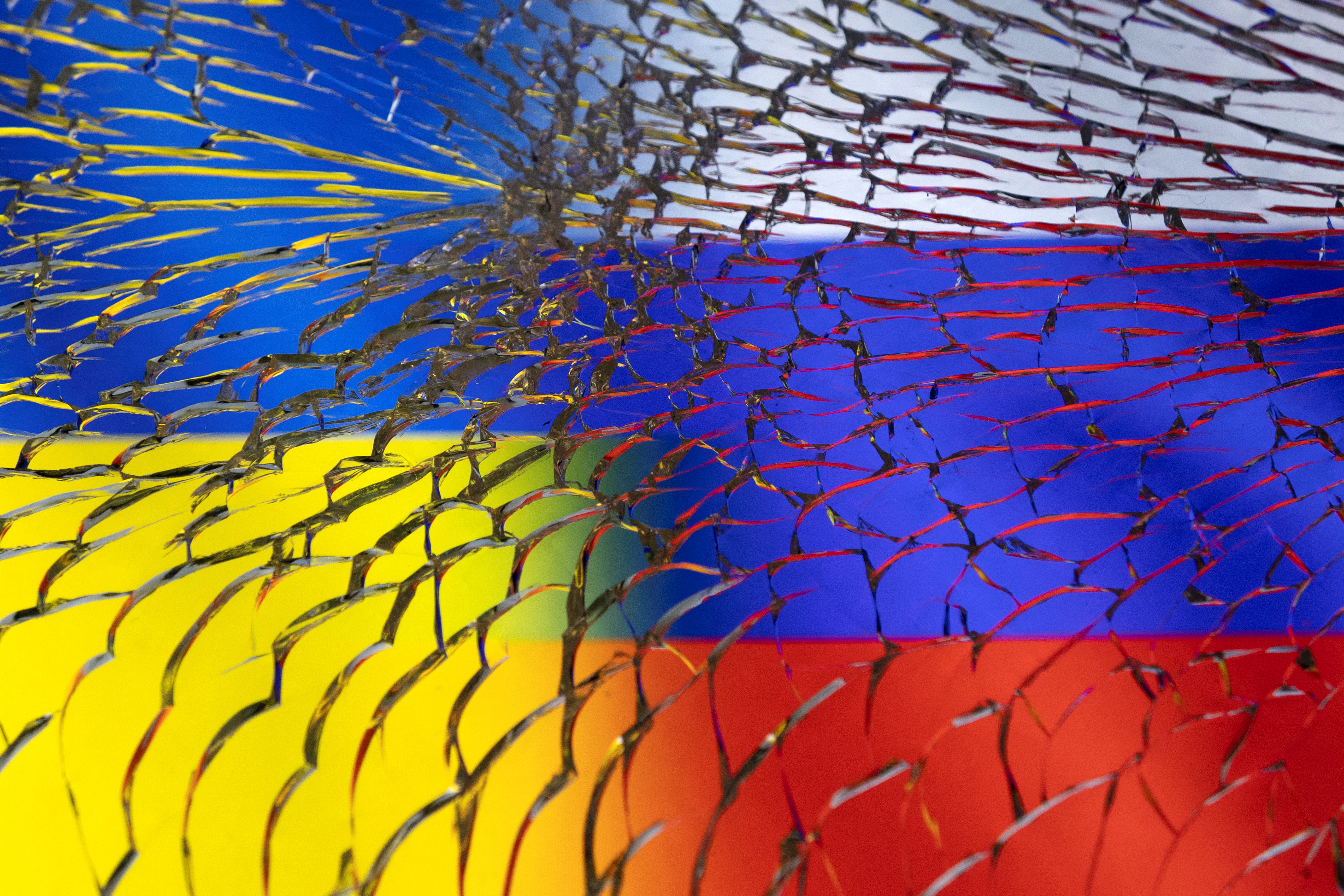Illustration shows Ukraine and Russian flags through broken glass
