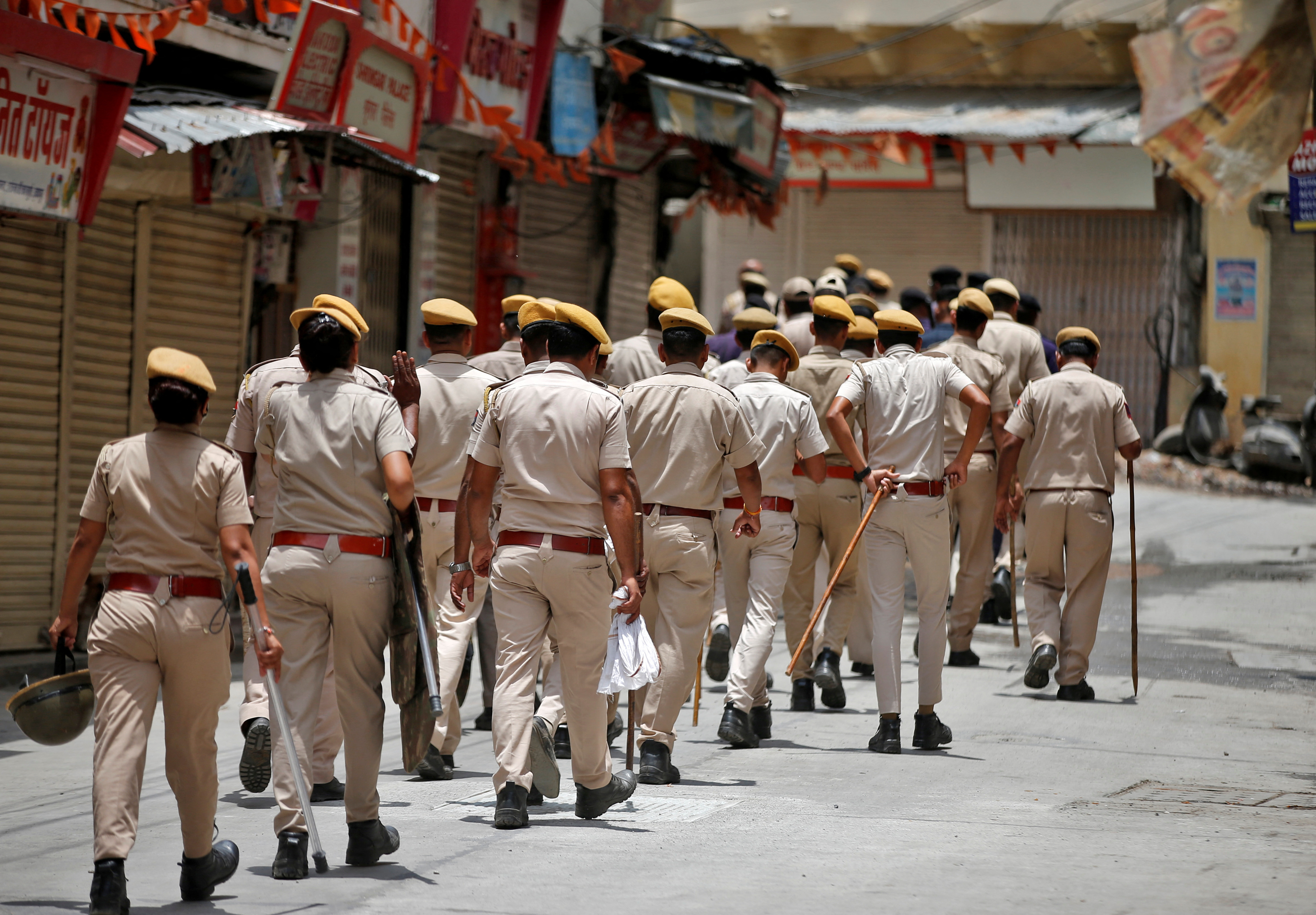 Members of the police patrol a street during restrictions imposed by authorities after the killing of Kanhaiya Lal Teli, a Hindu tailor, in Udaipur