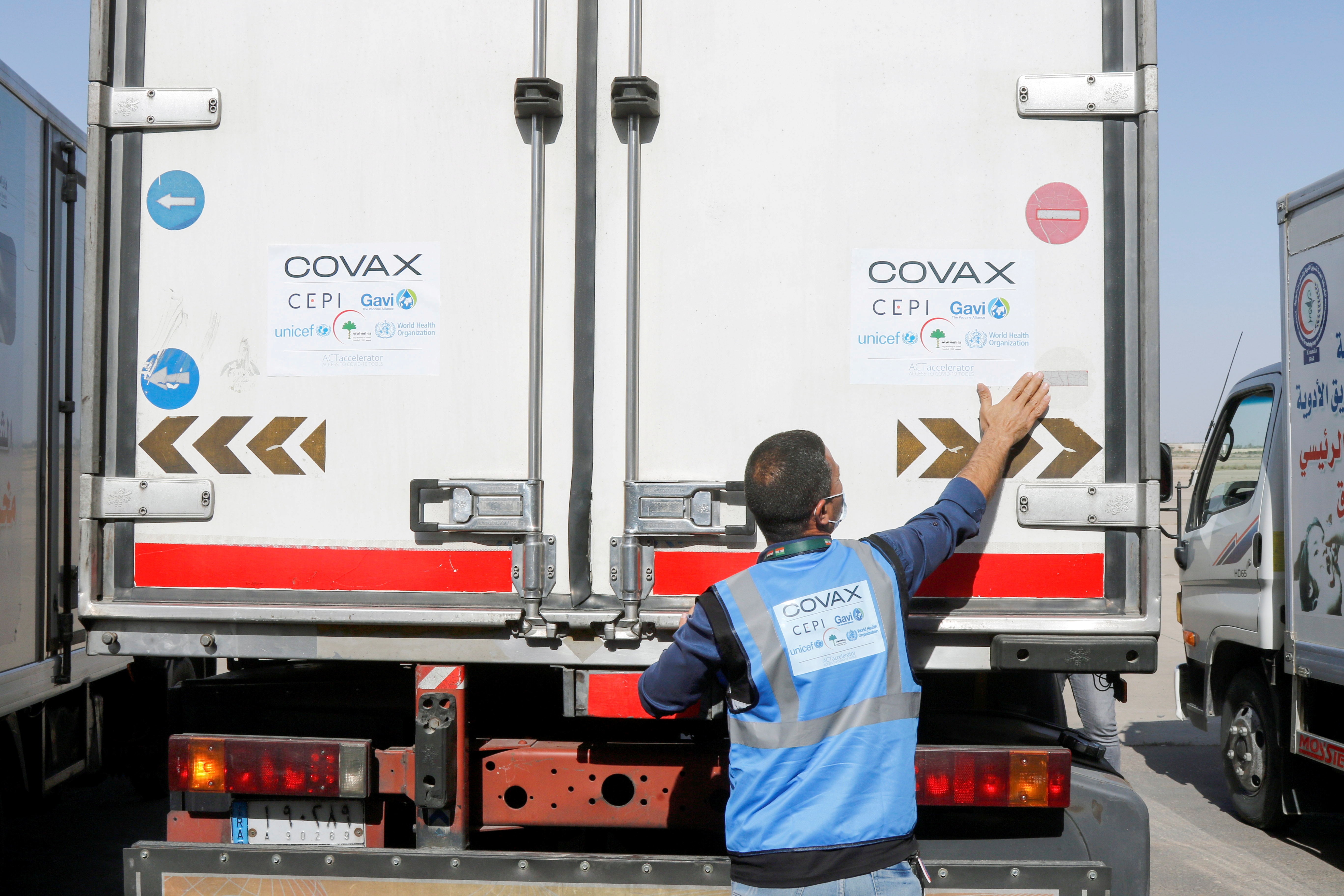A man checks a vehicle containing a shipment of the AstraZeneca vaccine against the coronavirus disease (COVID-19) at Baghdad International Airport, in Baghdad, Iraq March 25, 2021. REUTERS/Khalid al-Mousily