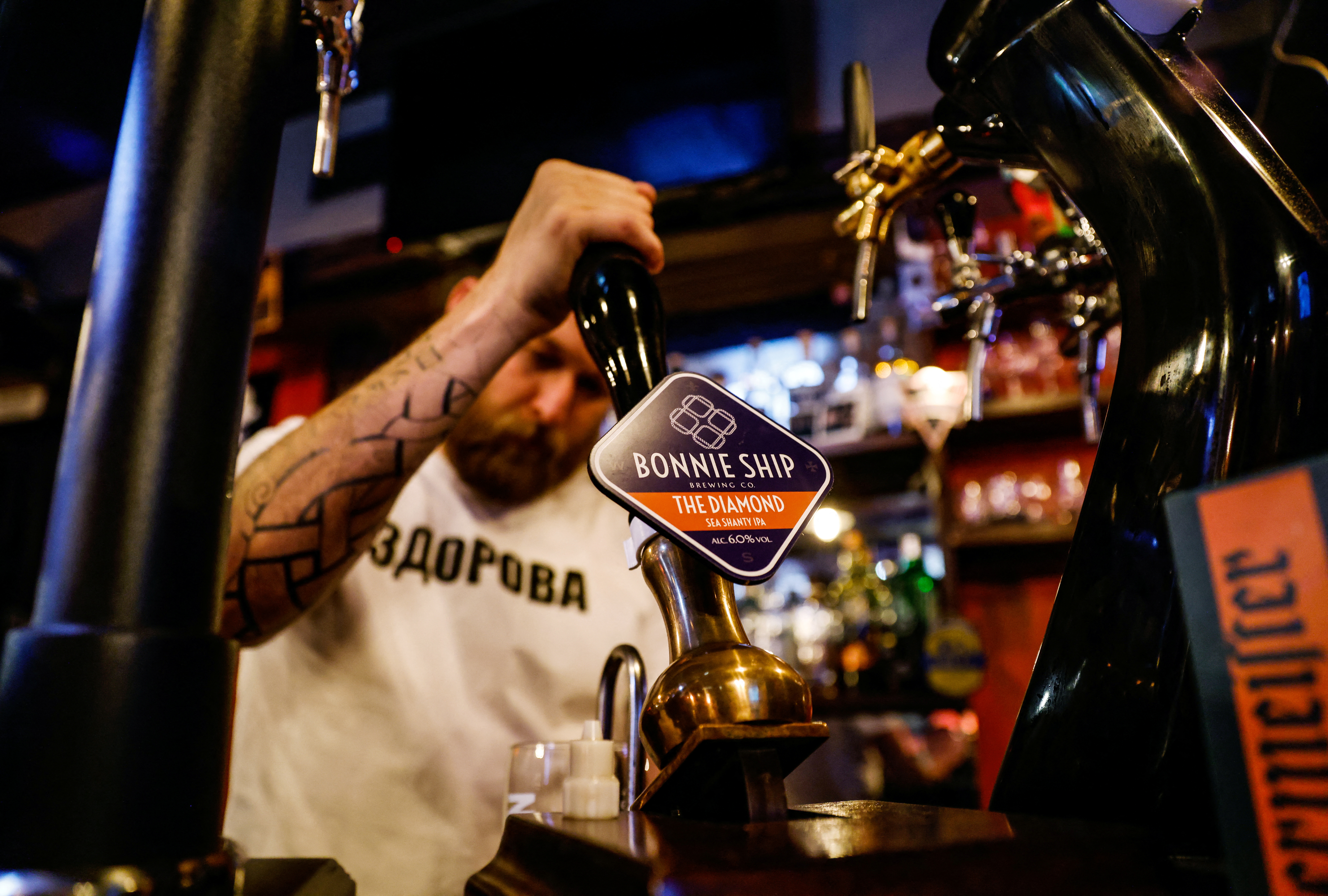 A bartender pours beer at a bar in Moscow