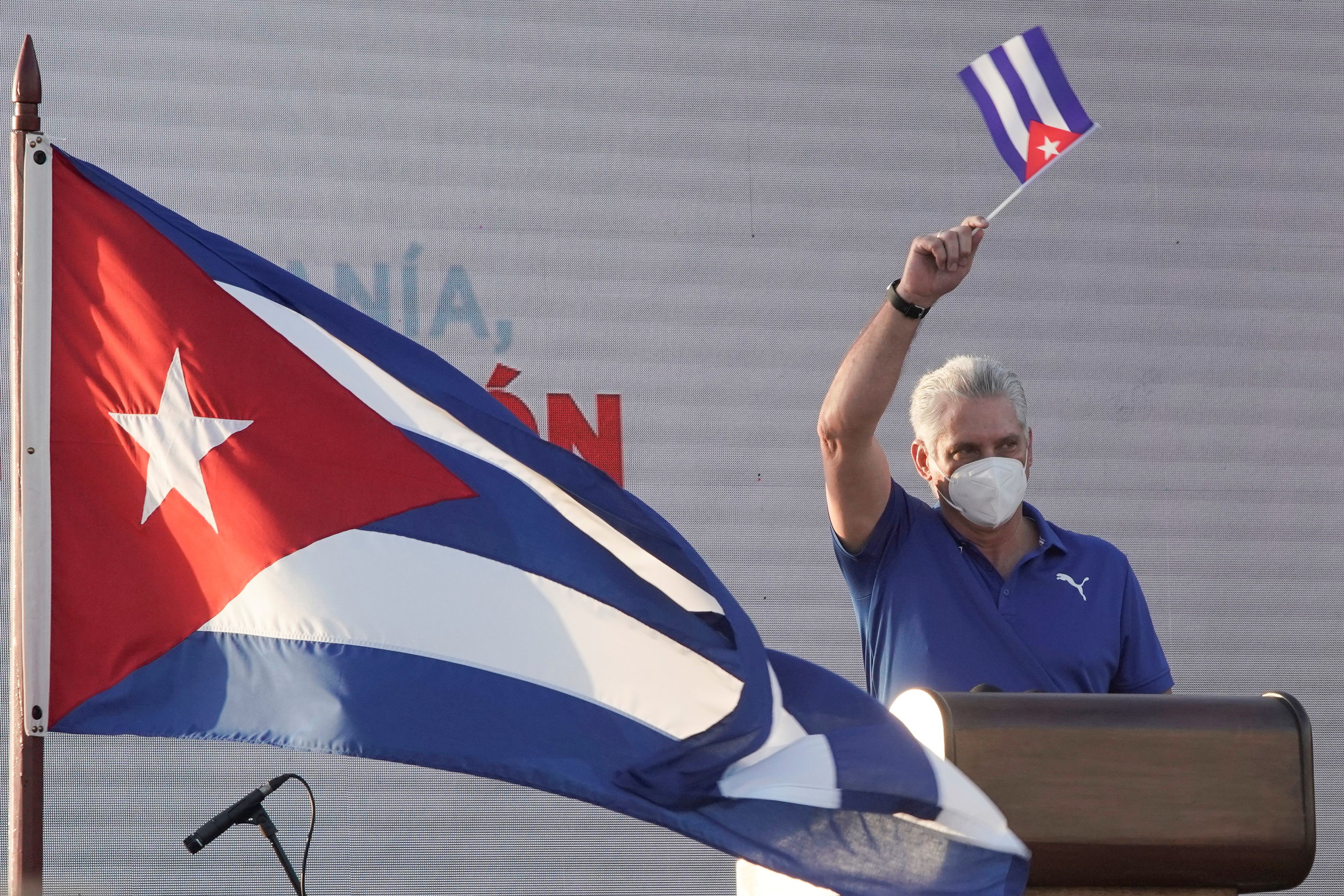 Cuba's President and First Secretary of the Communist Party Miguel Diaz-Canel waves a Cuban national flag as he delivers a speech during a rally in Havana, Cuba, July 17, 2021. REUTERS/Alexandre Meneghini