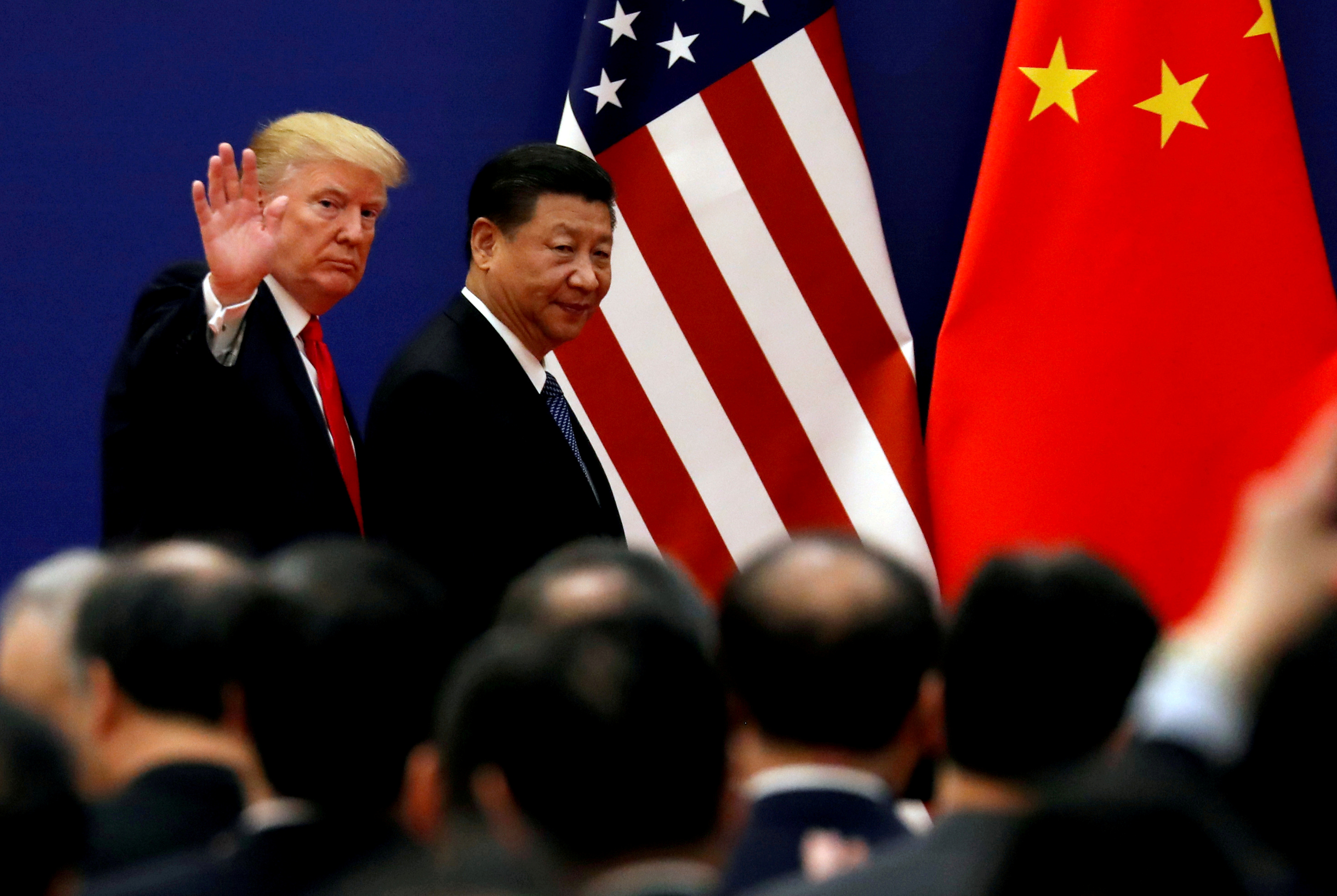 FILE PHOTO: U.S. President Donald Trump and China's President Xi Jinping meet business leaders at the Great Hall of the People in Beijing