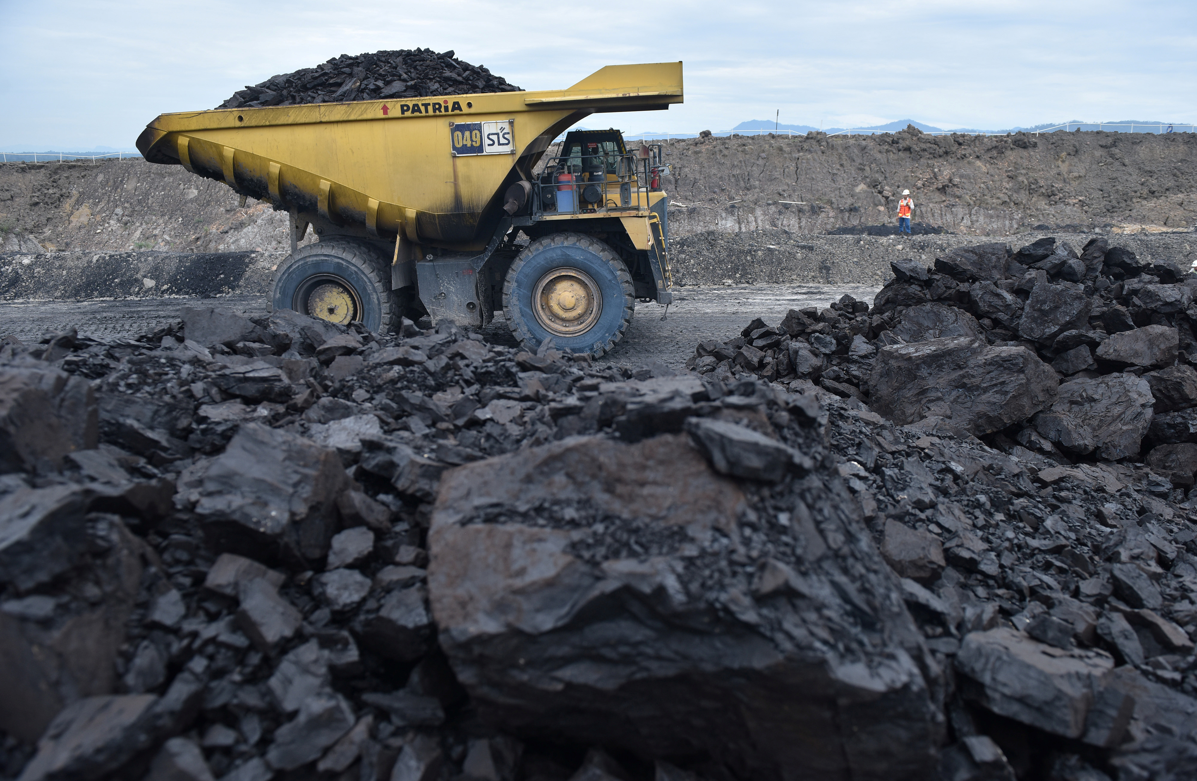 A truck carries coal at a mine in Idonesia