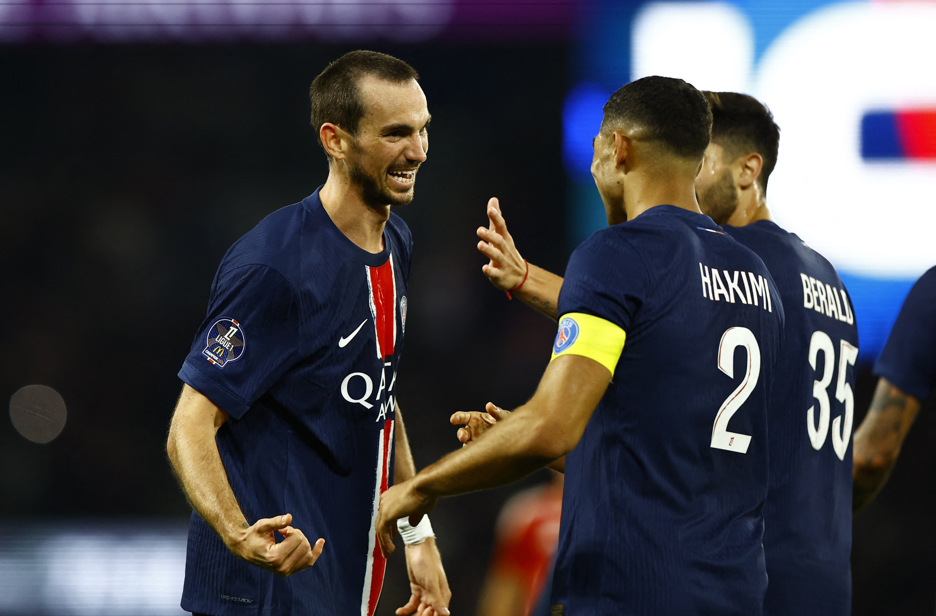 Soccer Football - Ligue 1 - Paris St Germain v Brest - Parc des Princes, Paris, France - September 14, 2024 Paris St Germain's Fabian Ruiz celebrates scoring their second goal with Achraf Hakimi REUTERS/Abdul Saboor