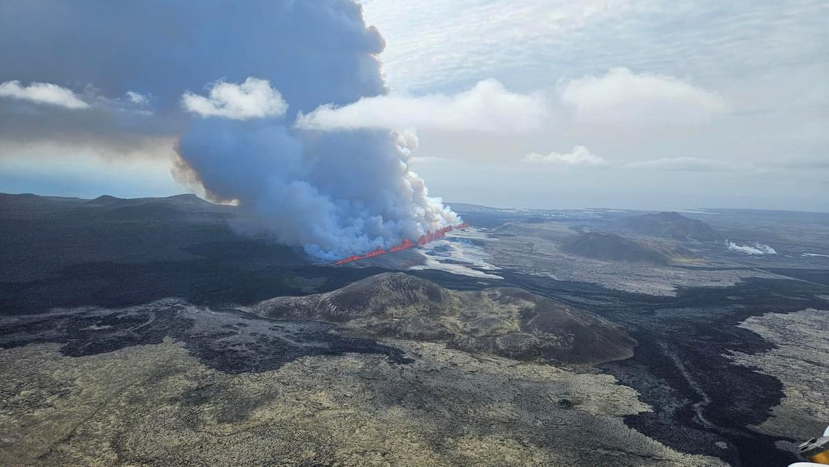 A volcano spews lava and smoke as it erupts on Reykjanes Peninsula in Iceland