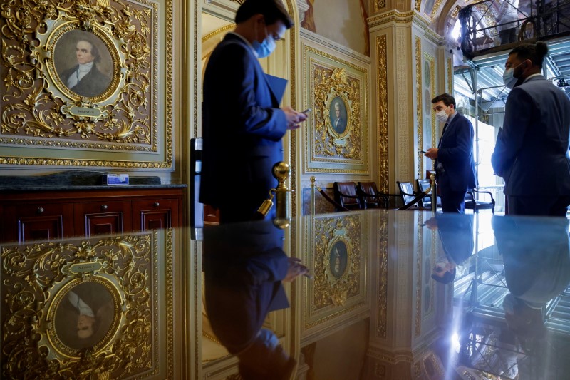 Senate staffers wait in the Senate Reception Room between votes on the Senate floor at the U.S. Capitol in Washington