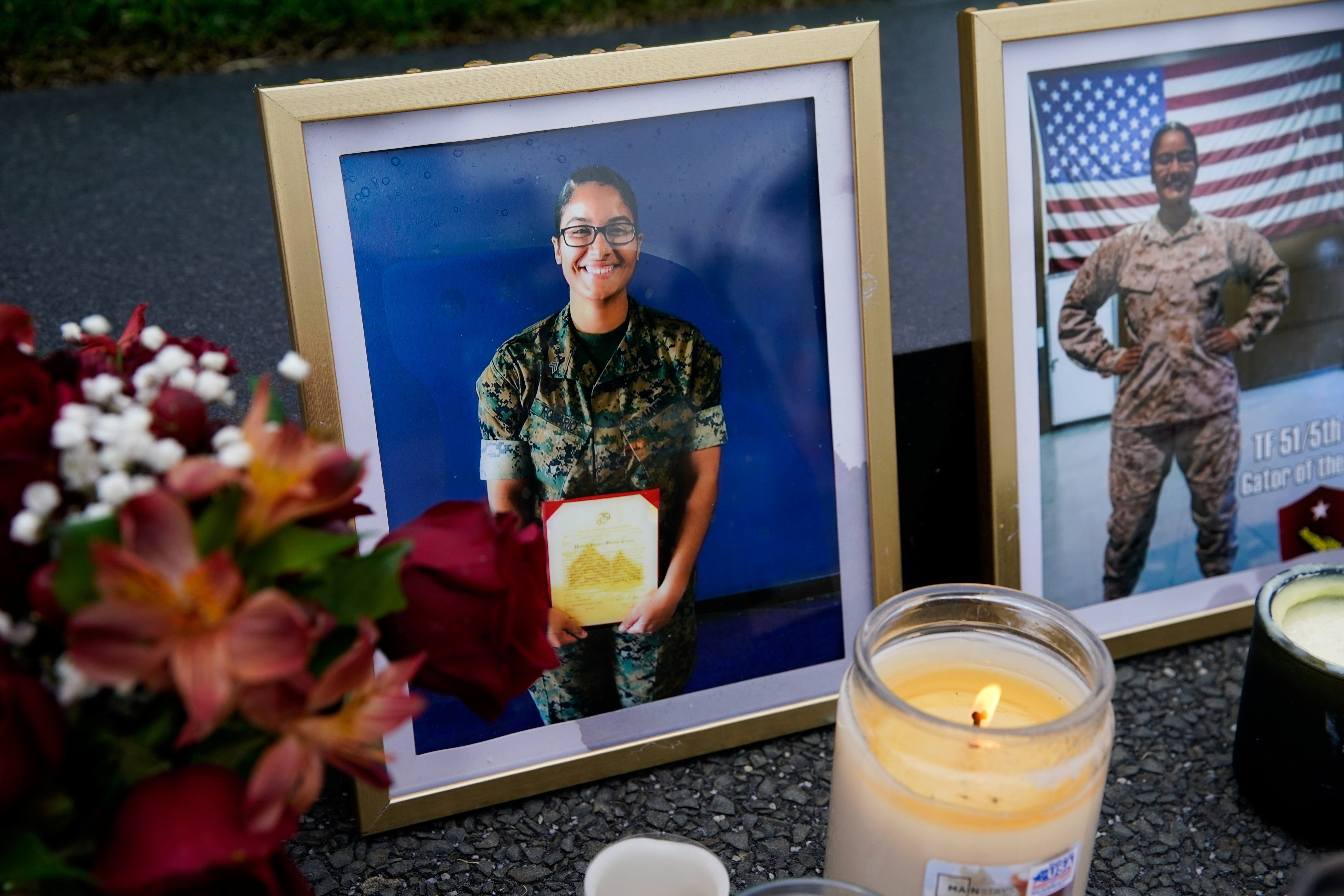 Photos of U.S. Marine Corps Sergeant Johanny Rosario Pichardo are seen at a makeshift memorial for the 13 U.S. troops killed in Afghanistan on August 26, 2021, at the U.S. Marine Corps War Memorial in Arlington, Virginia, U.S., August 29, 2021. REUTERS/Elizabeth Frantz