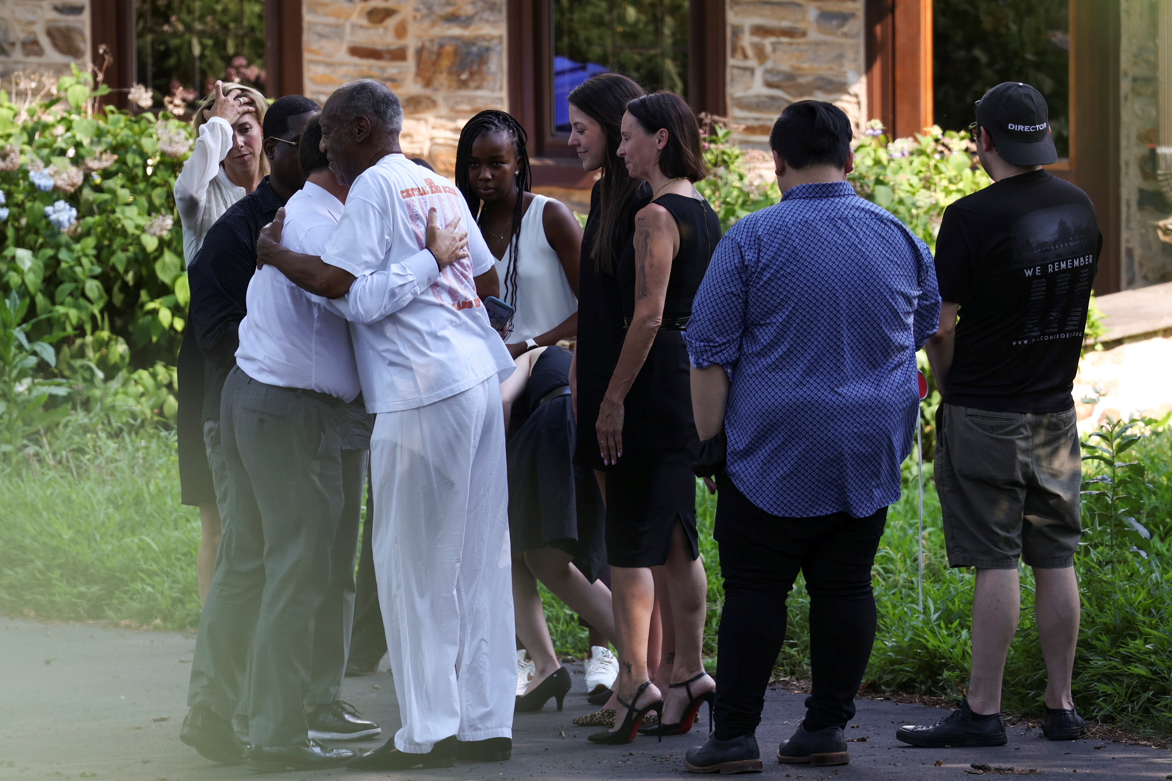 Bill Cosby is greeted outside his house after Pennsylvania's highest court overturned his sexual assault conviction and ordered him released from prison immediately, in Elkins Park