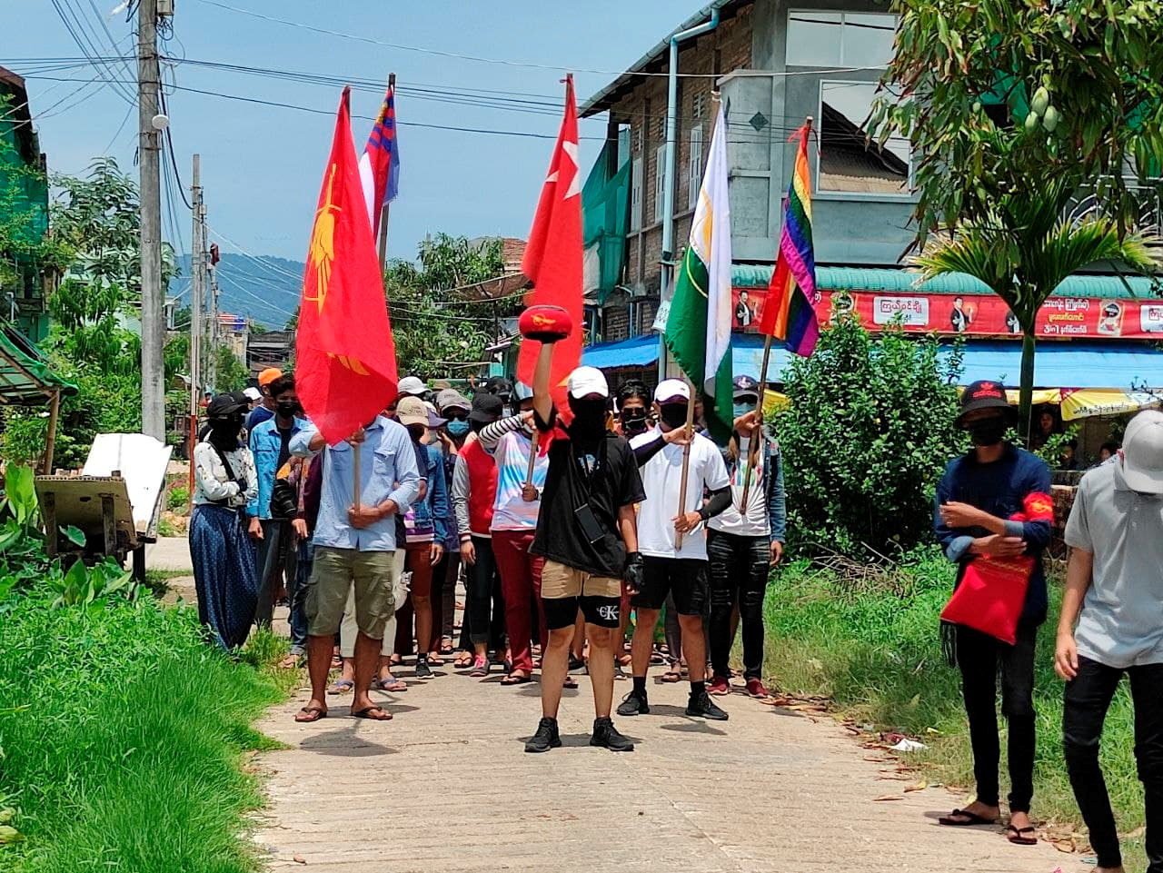 Demonstrators carry flags as they march to protest against the military coup, in Dawei, Myanmar April 27, 2021. Courtesy of Dawei Watch/via REUTERS   