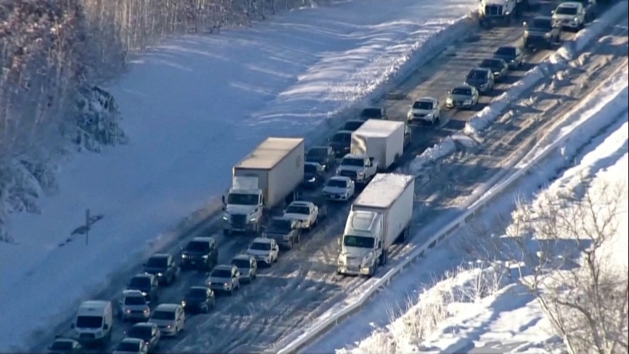 Vehicles are seen in a still image from video as authorities worked to reopen an icy stretch of Interstate 95 closed after a storm blanketed the U.S. region in snow a day earlier, near Garrisonville, Virginia, U.S. January 4, 2022.  ABC/WJLA via REUTERS 