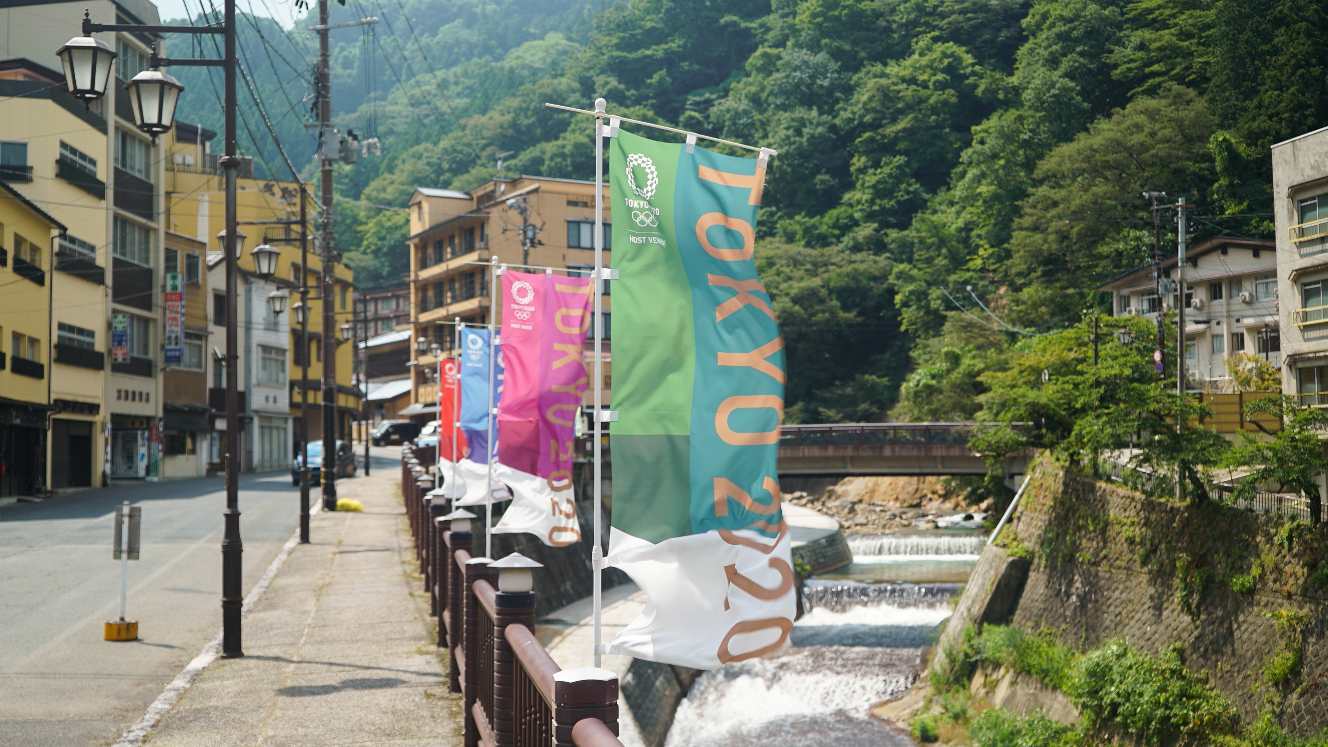 Tokyo 2020 banners flutter along a riverwalk in Tsuchiyu Onsen Machi