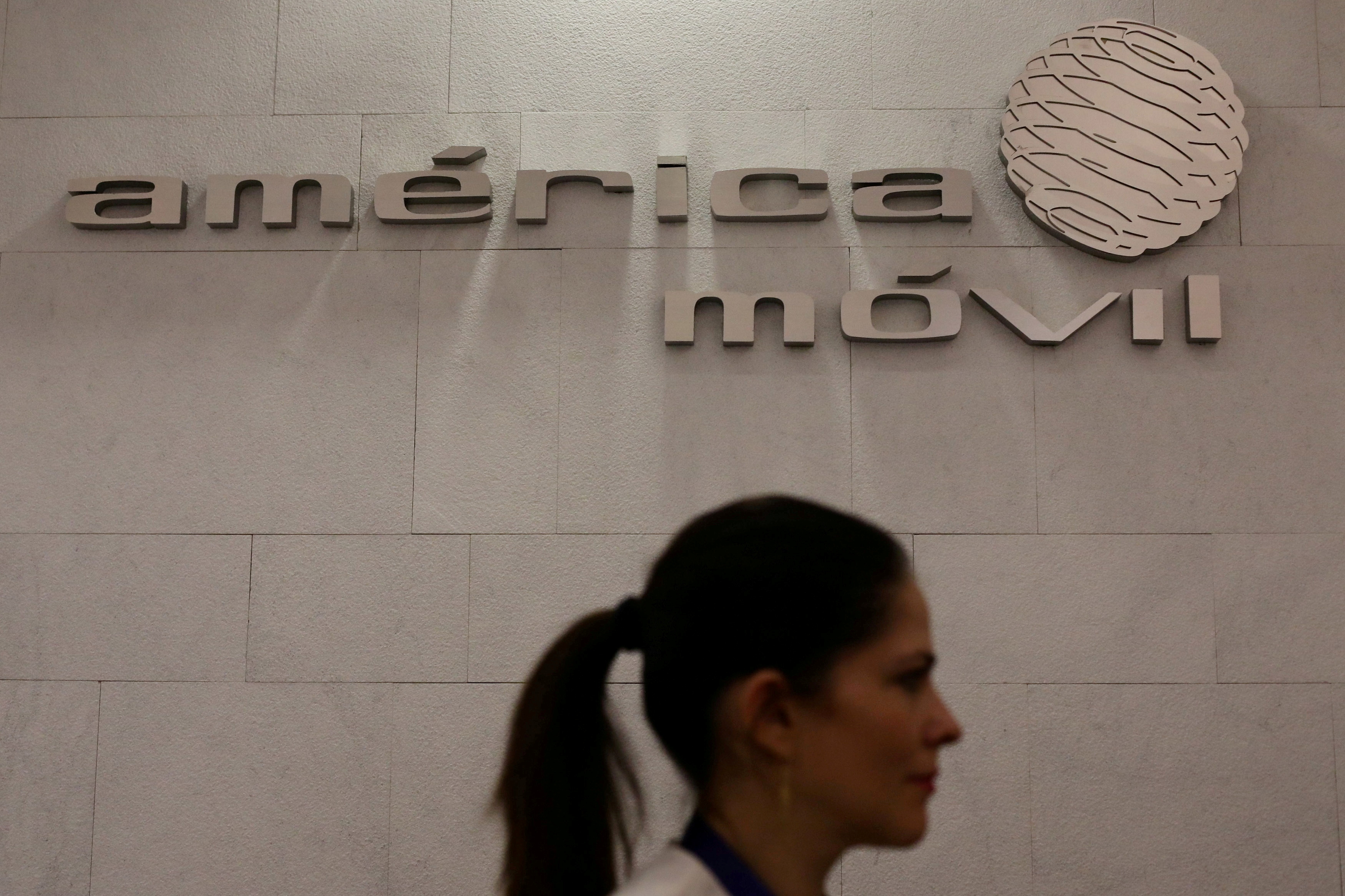 The logo of America Movil is pictured on the wall of a reception area in the company's corporate offices in Mexico City, Mexico, May 18, 2017. REUTERS/Edgard Garrido