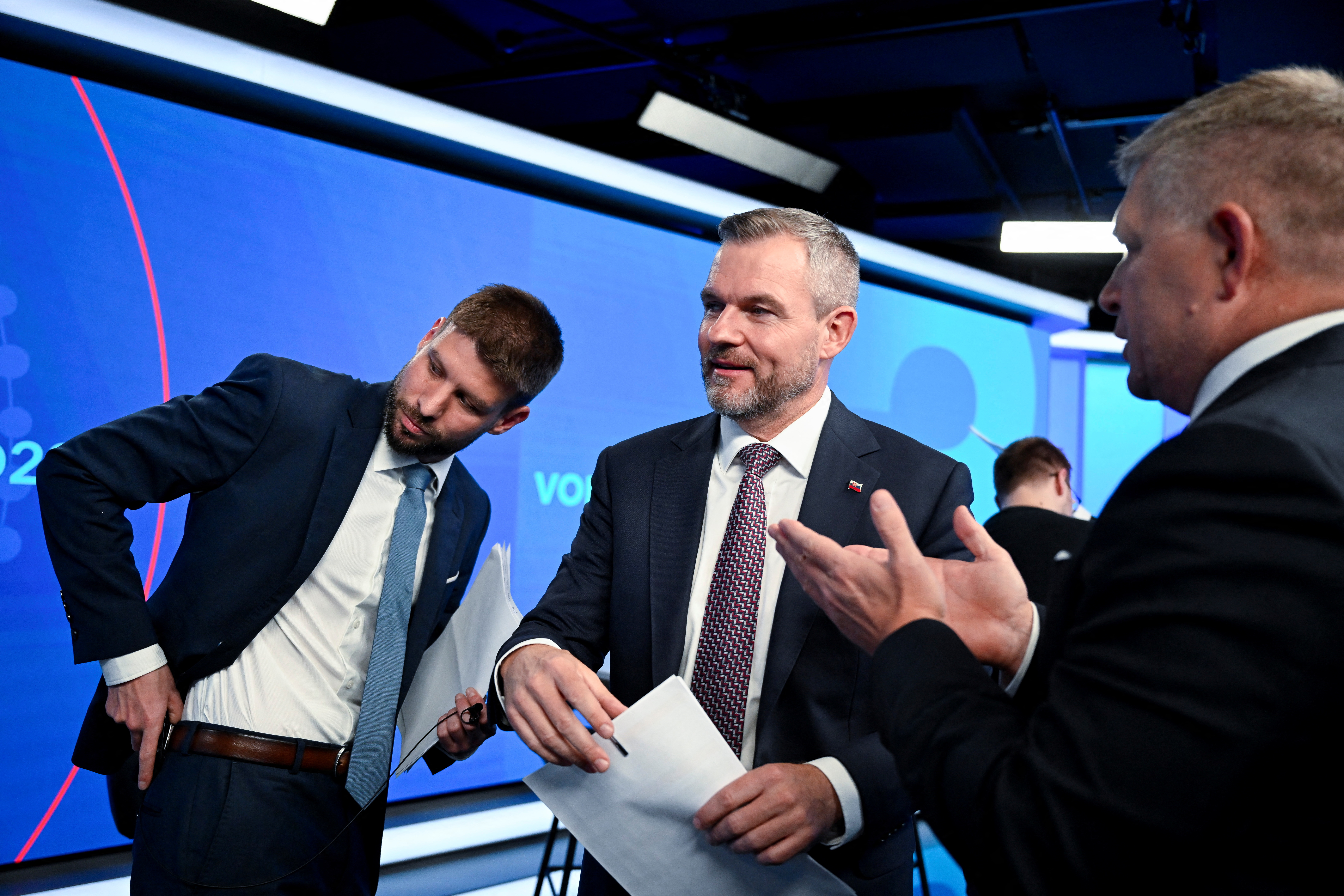Michal Simecka, leader of the Progressive Slovakia party, Peter Pellegrini, leader of the HLAS party, and Robert Fico, leader of the SMER-SSD party, stand next to each other after a televised debate at TV TA3
