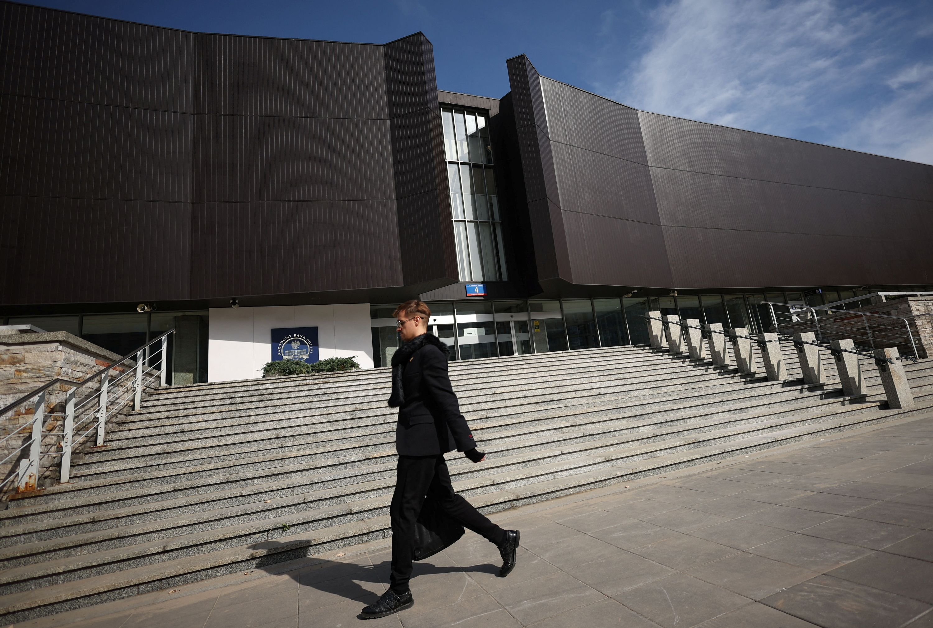 A man walks in front of the National Bank of Poland (NBP) building in Warsaw