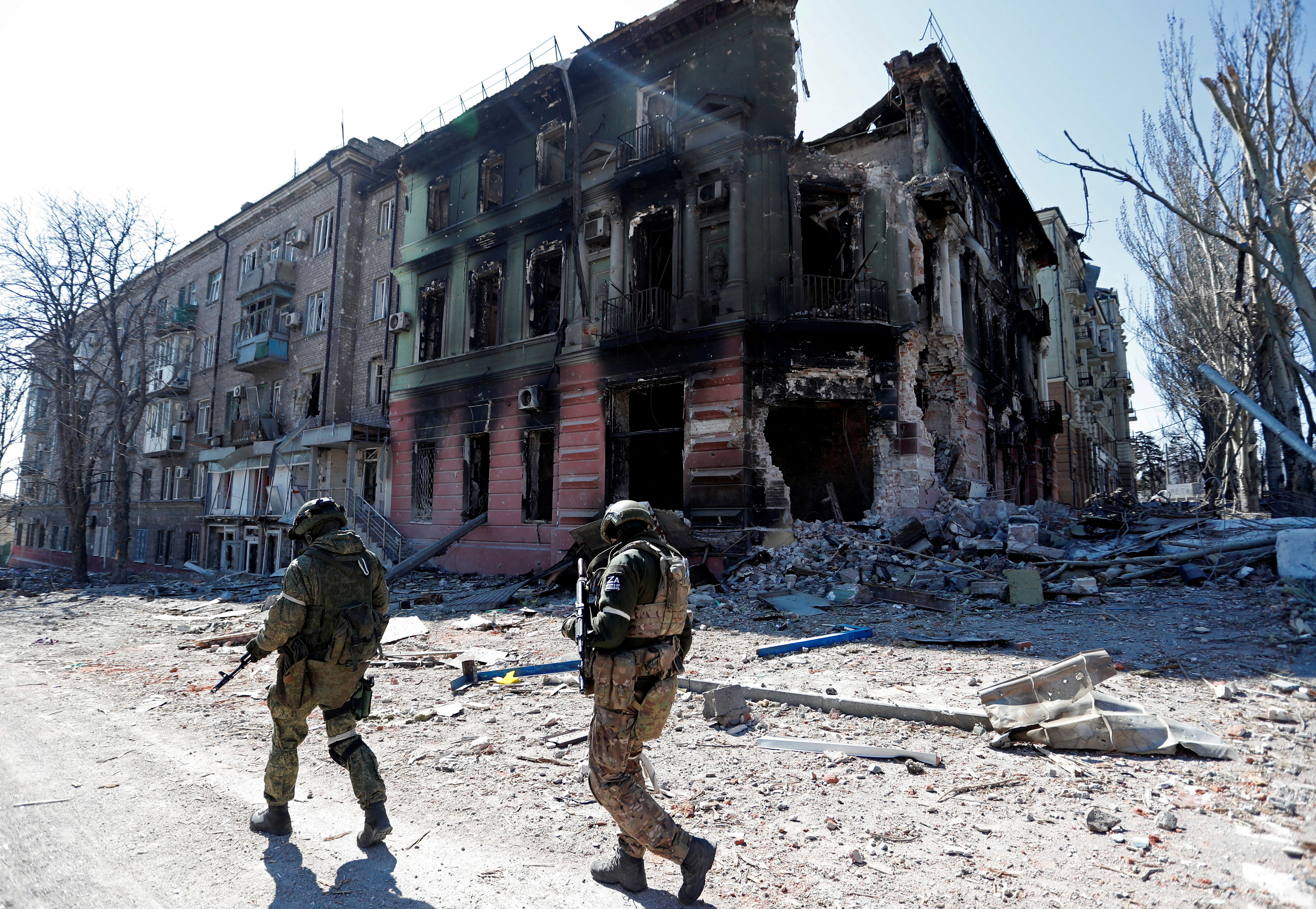Service members of pro-Russian troops inspect streets of Mariupol