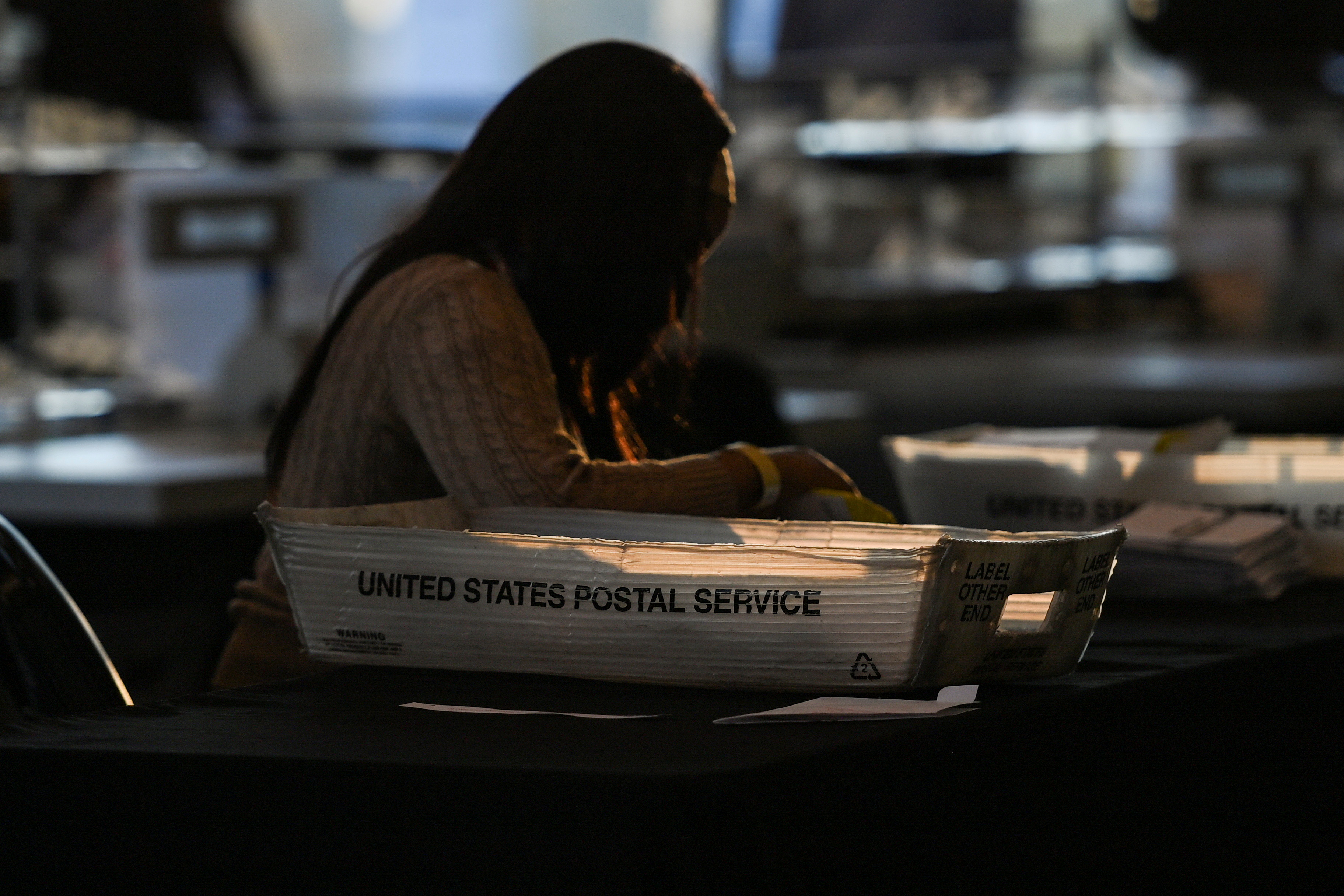 An employee of the Fulton County Board of Registration and Elections processes ballots in Atlanta, Georgia, U.S., November 4, 2020. REUTERS/Brandon Bell/File Photo