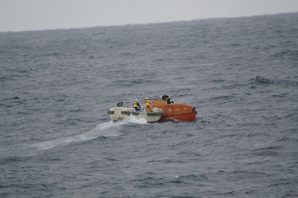 A life boat drifts at sea near the site of a cargo ship that sank off southwestern Japan