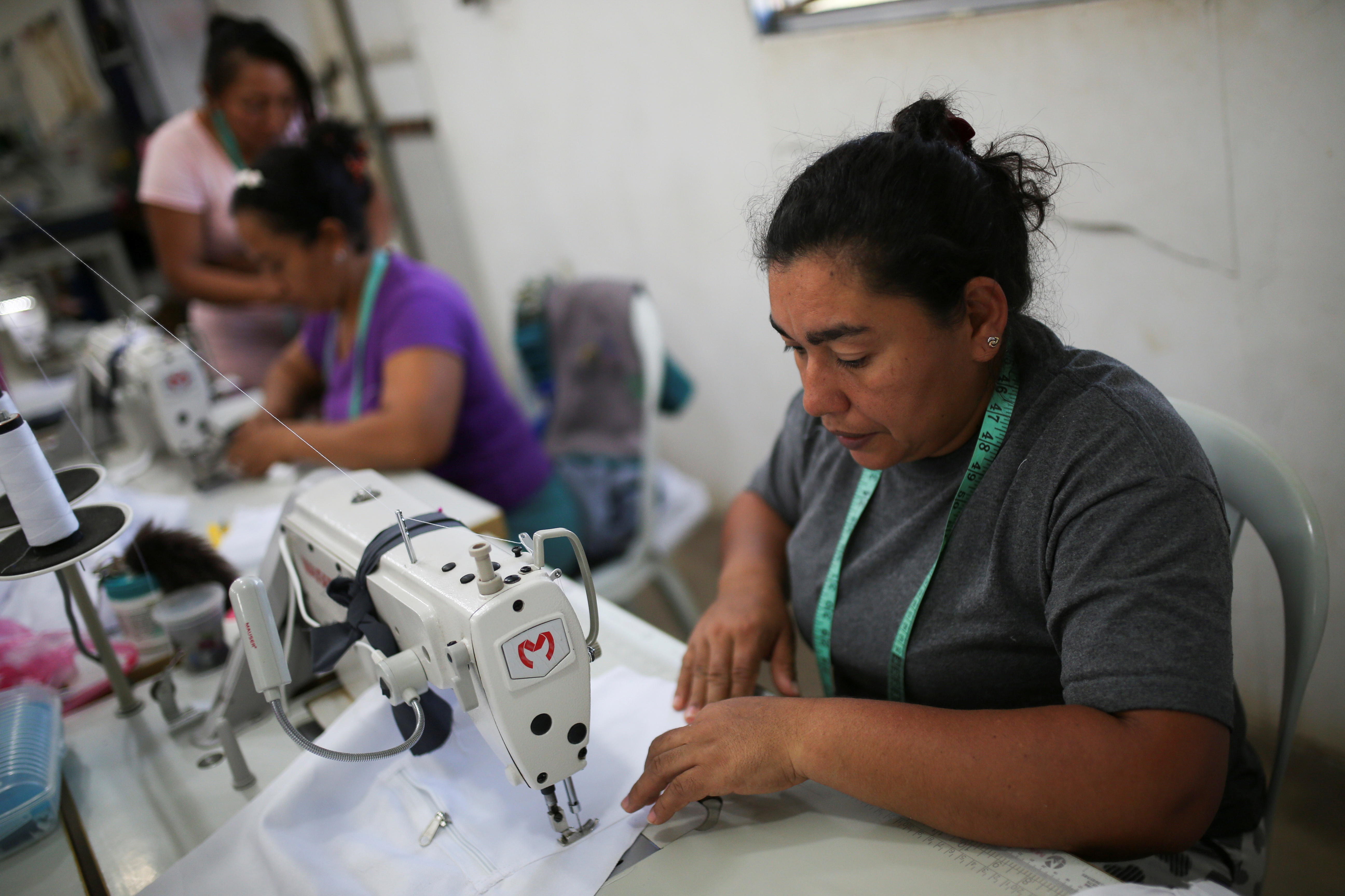 Yinis Pimienta, 40, former rebel of the Revolutionary Armed Forces of Colombia (FARC), makes clothes at a tailoring shop which is part of a productive project, at a reintegration camp in Pondores, Colombia November 9, 2021.  REUTERS/Luisa Gonzalez