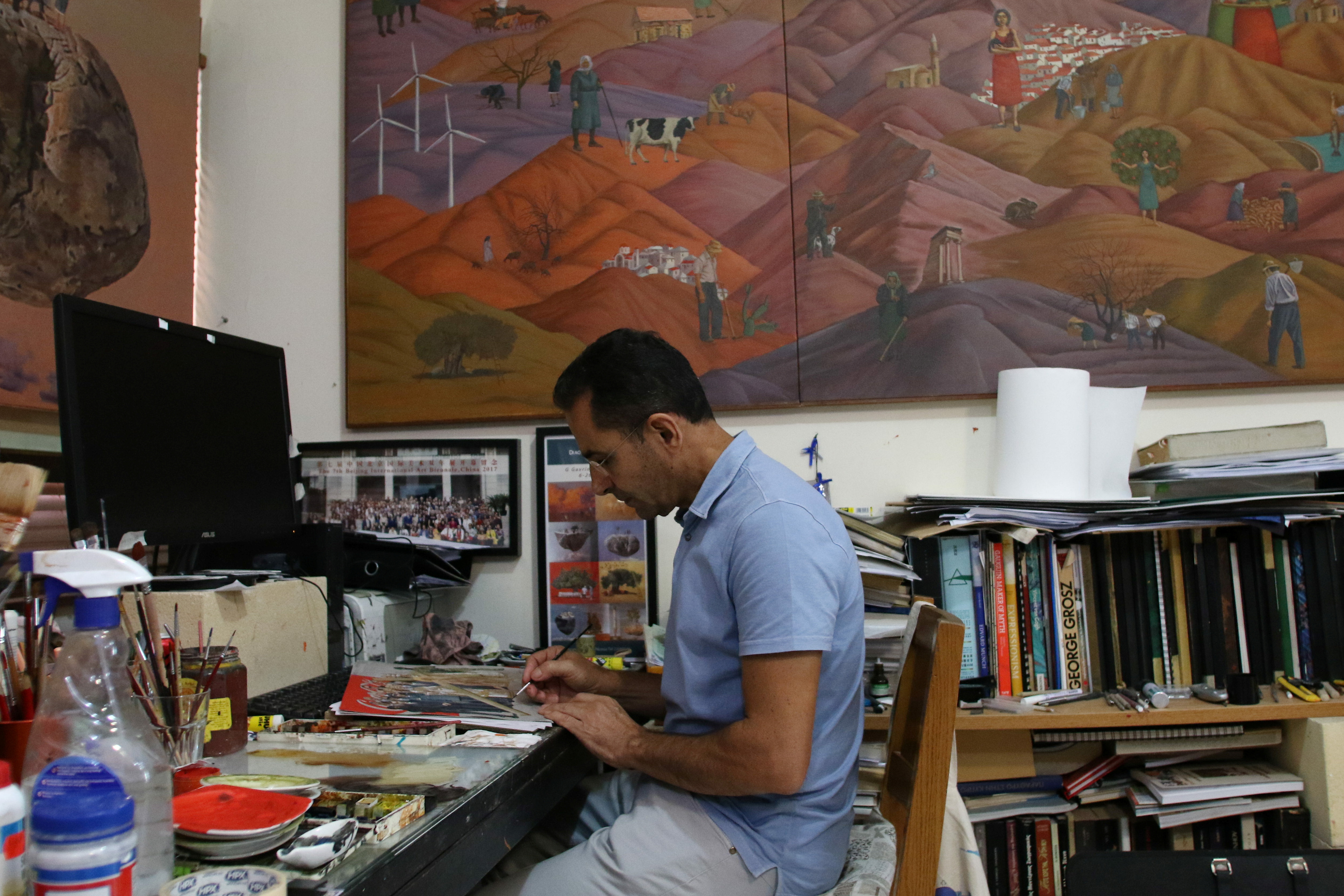 George Gavriel paints in his home studio in Kokkinotrimithia, Cyprus, October 15, 2021, REUTERS/Yiannis Kourtoglou