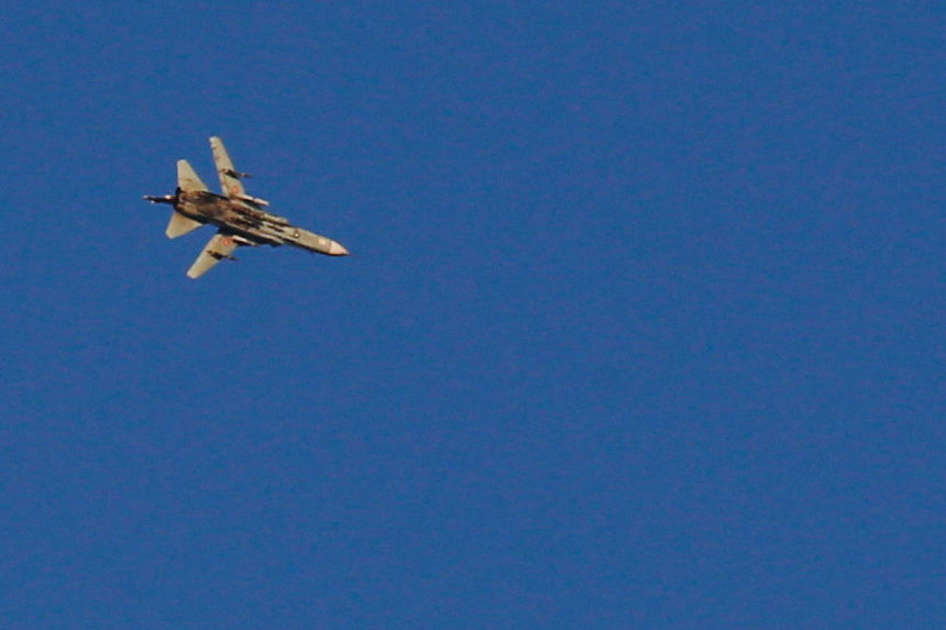 A war jet flies above Syria near the Israeli Syrian border as it is seen from the Israeli-occupied Golan Heights