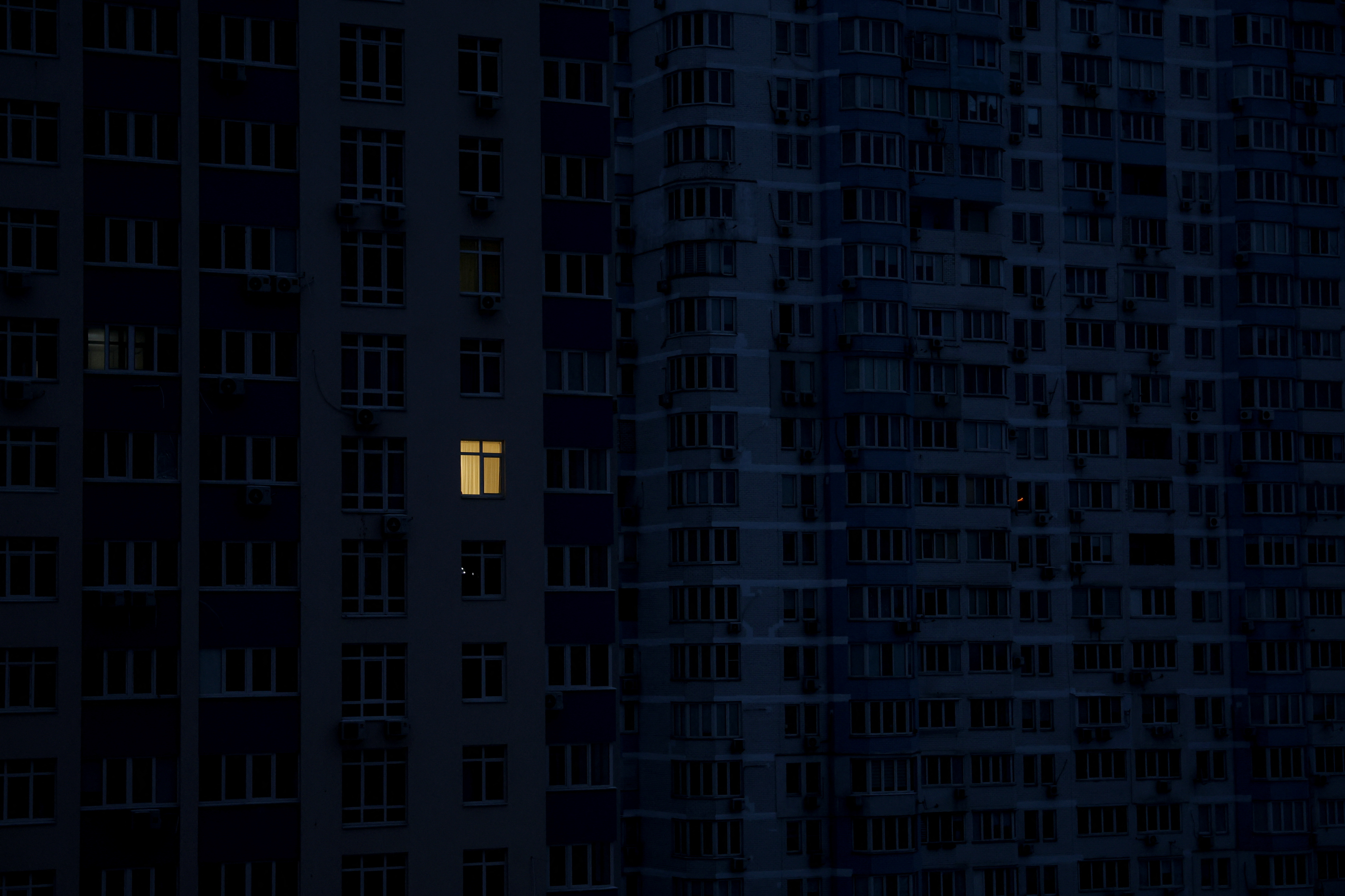 Lights can be seen in an apartment during a power outage in Kyiv