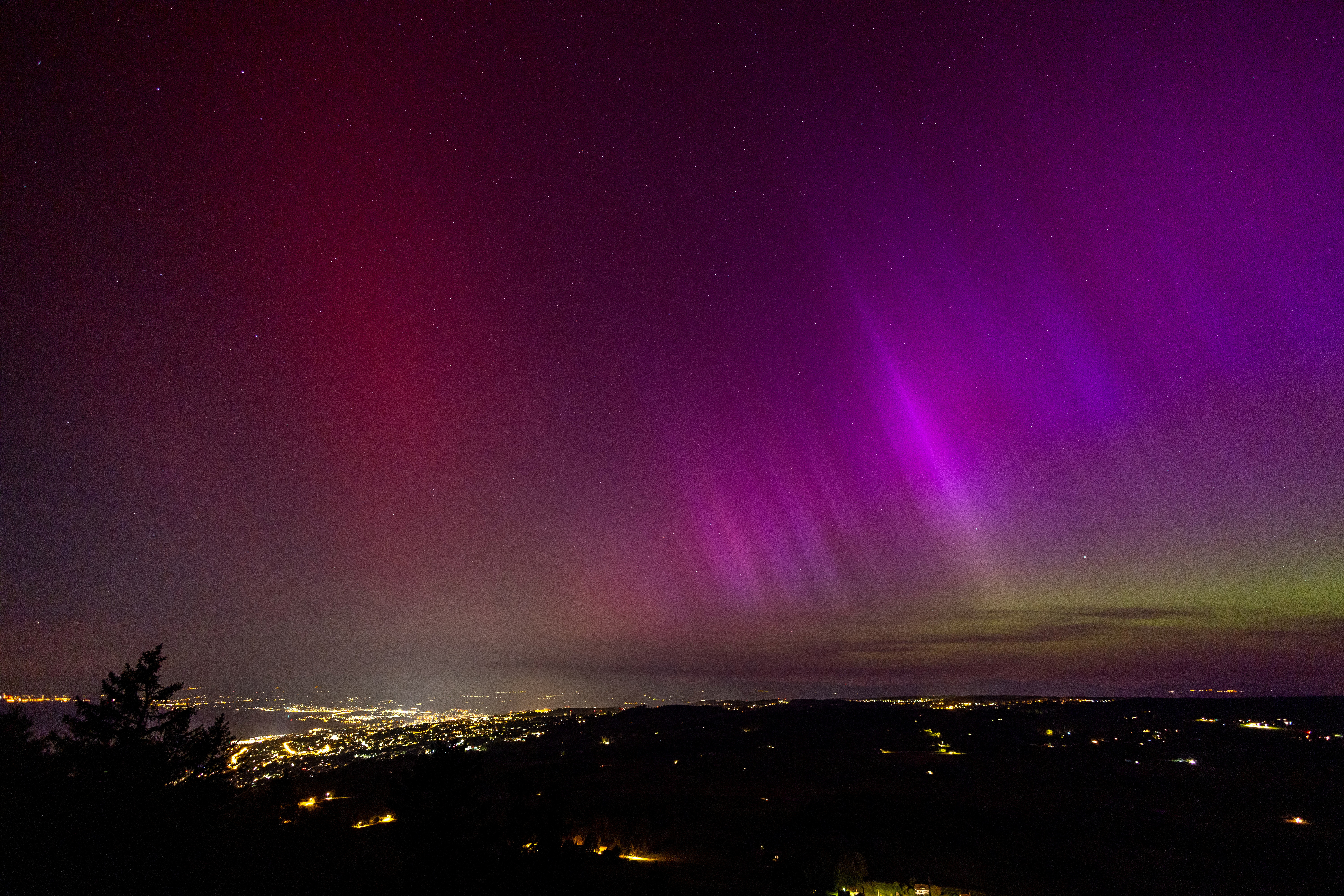 An aurora borealis is seen above Lausanne and the Jura from the Tour de Gourze