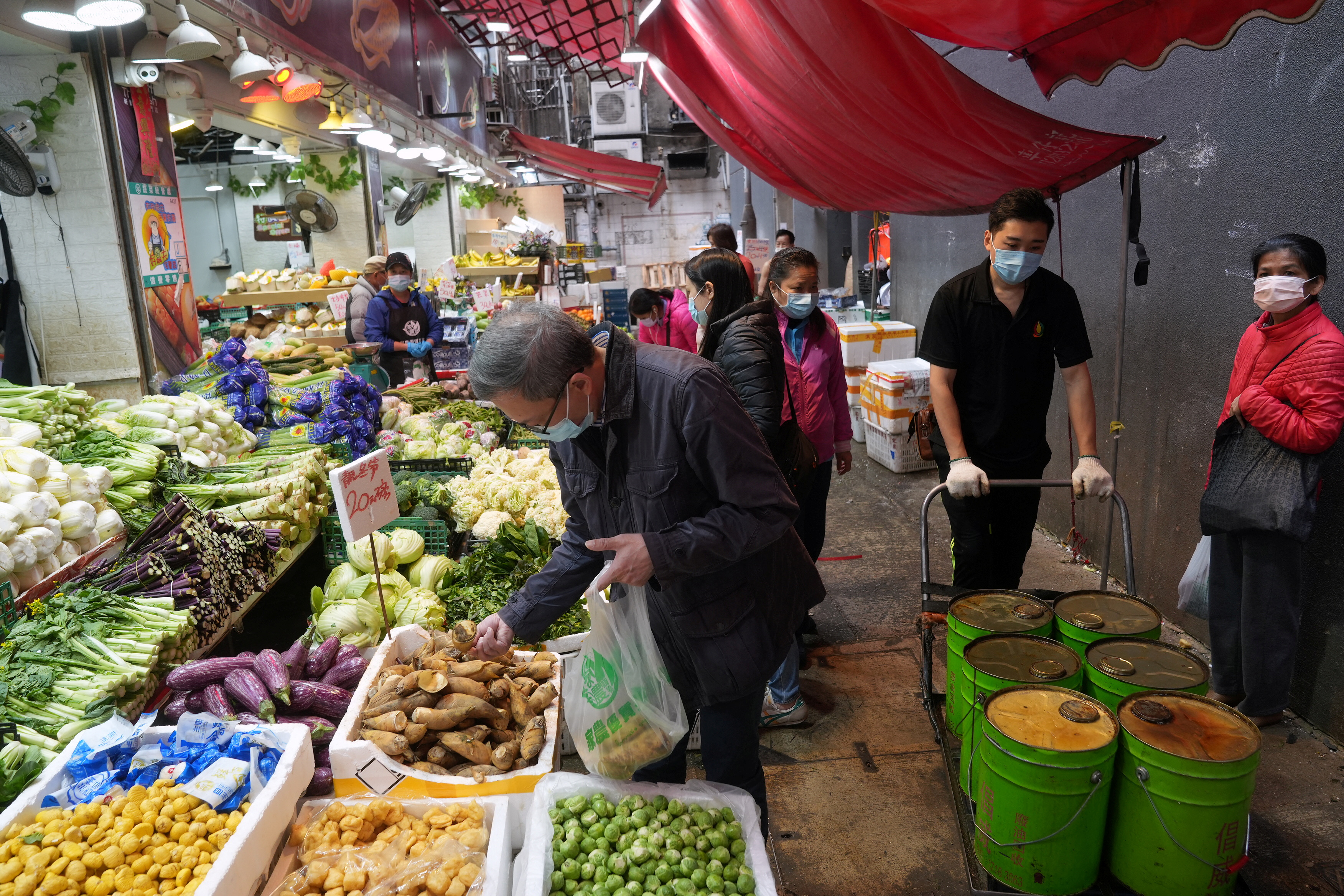 Customers shop at a wet market in Hong Kong
