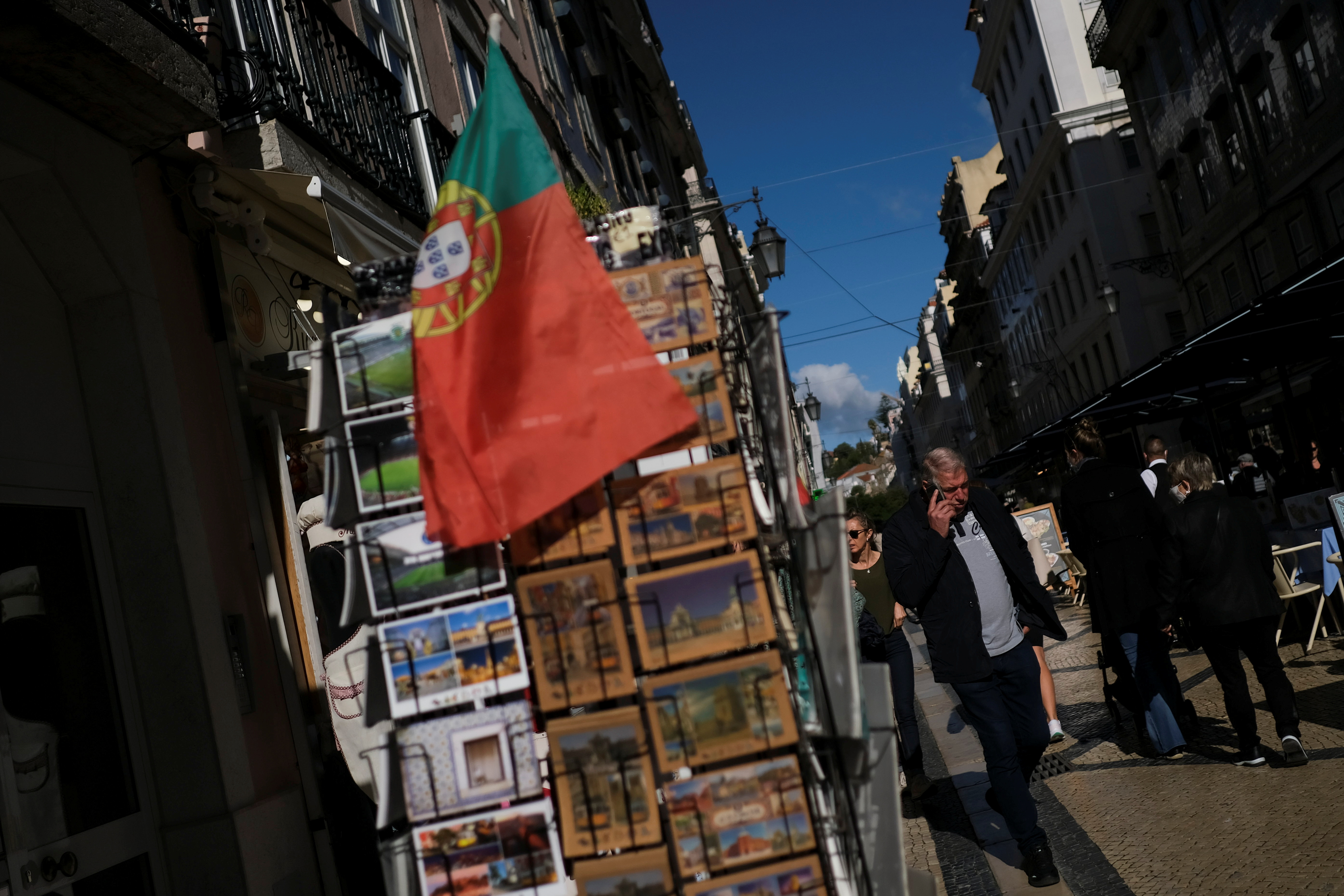 People walk along a street in downtown Lisbon