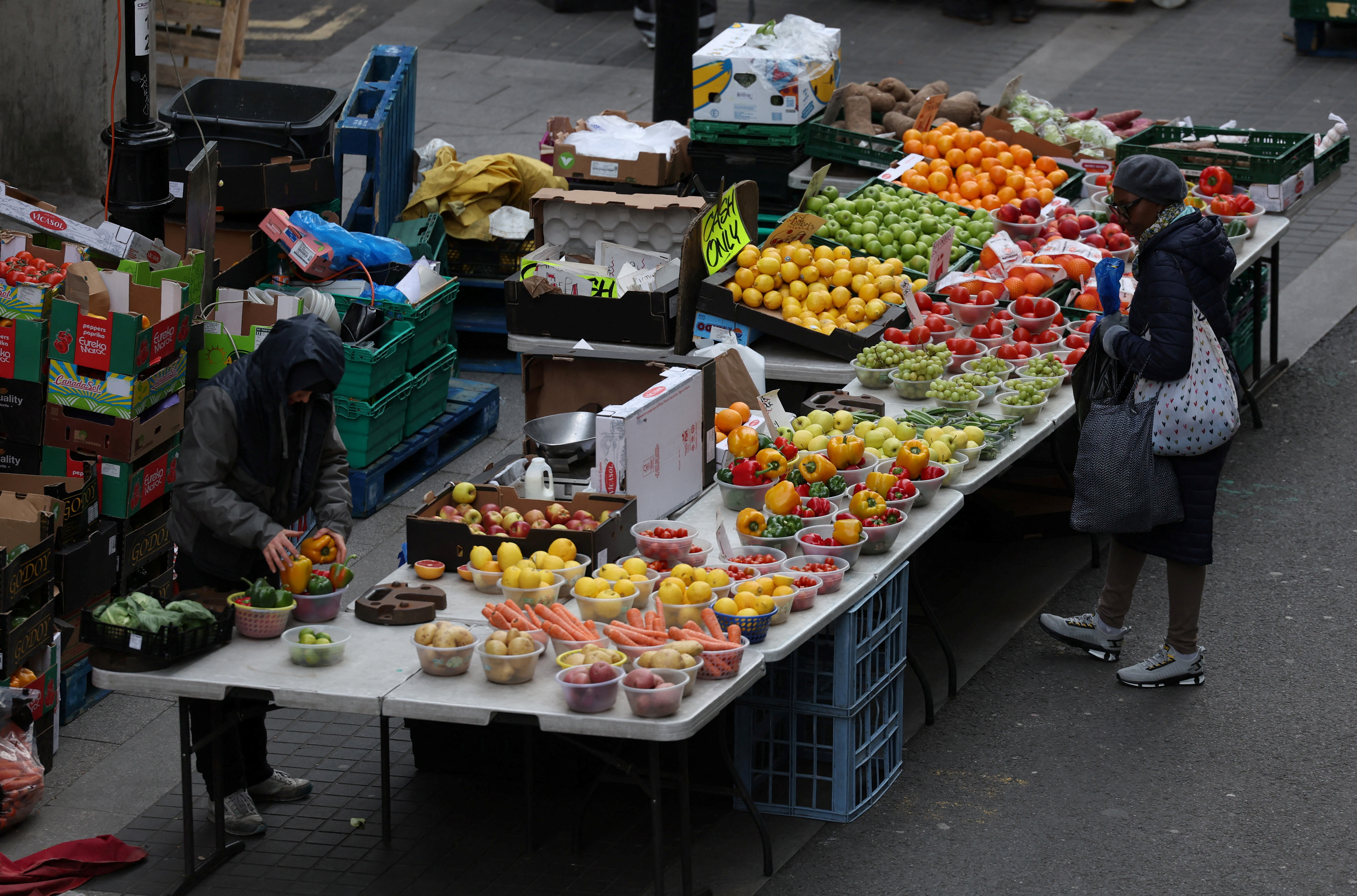 A customer waits to be served at a stall on Surrey Street market in Croydon