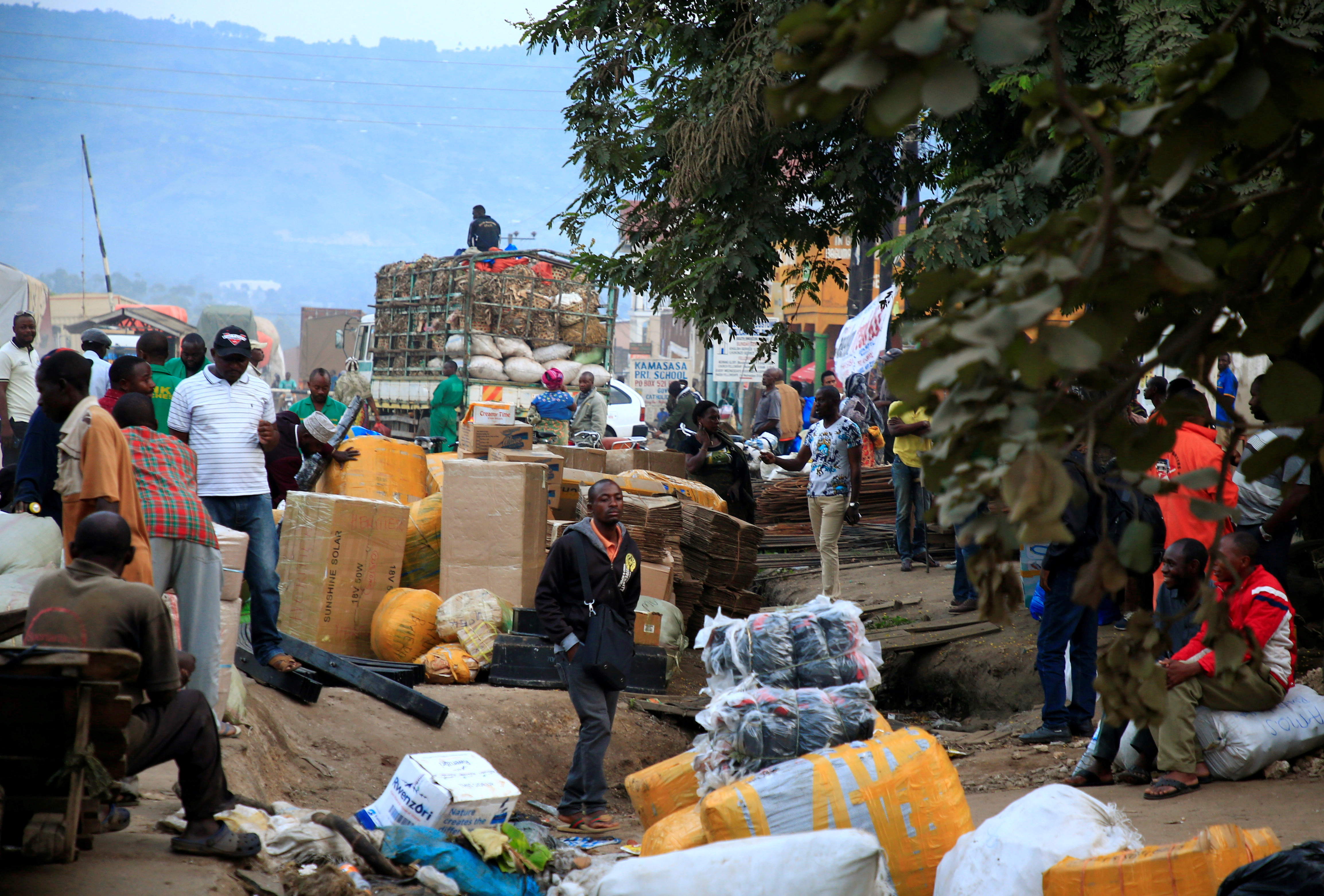 Ugandan business people are seen at a market with their merchandises for sale at Mpondwe border that separates Uganda and the Democratic Republic of Congo in Mpondwe