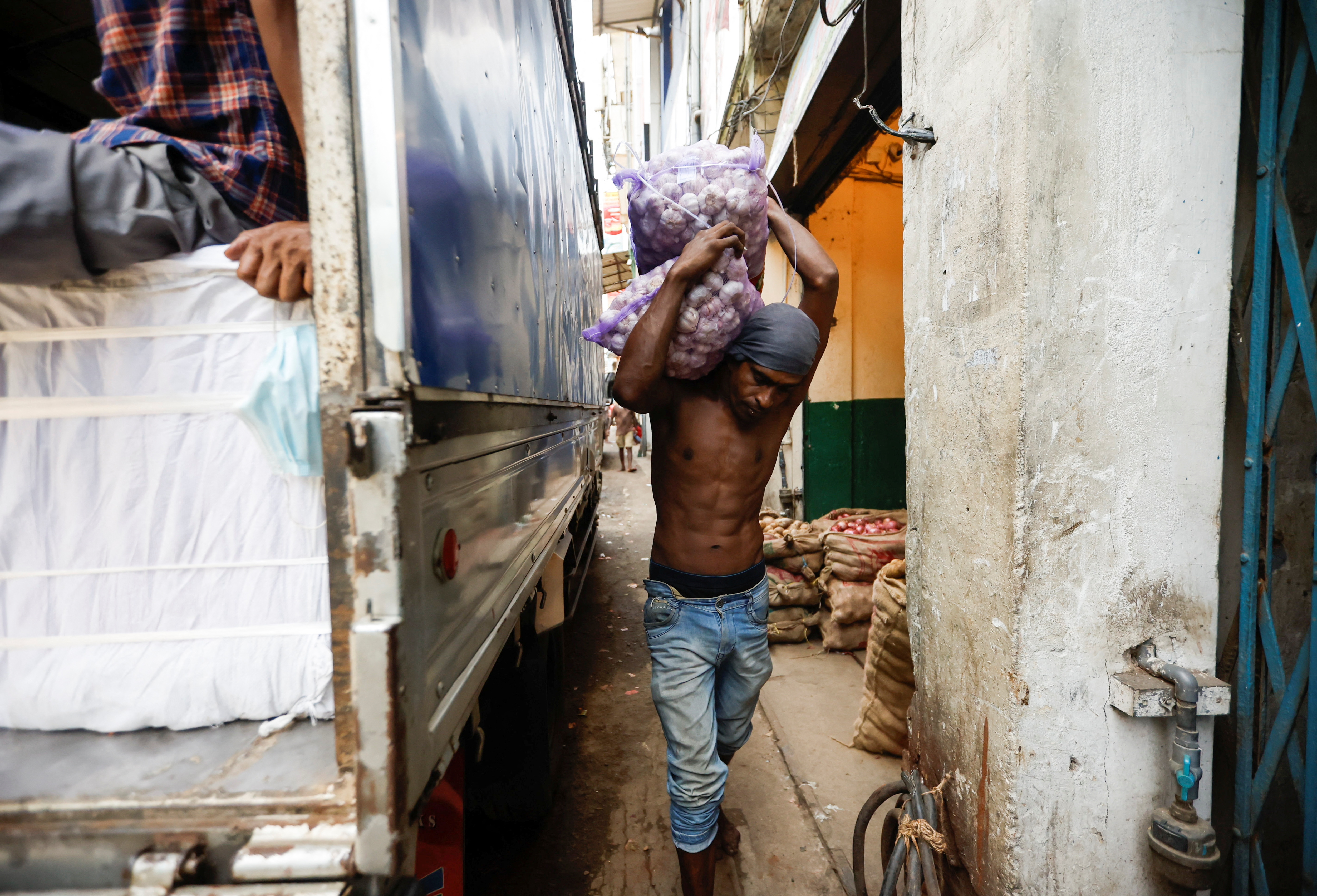A man carries a sack of garlic at the Pettah Market, amid the country's economic crisis, in Colombo