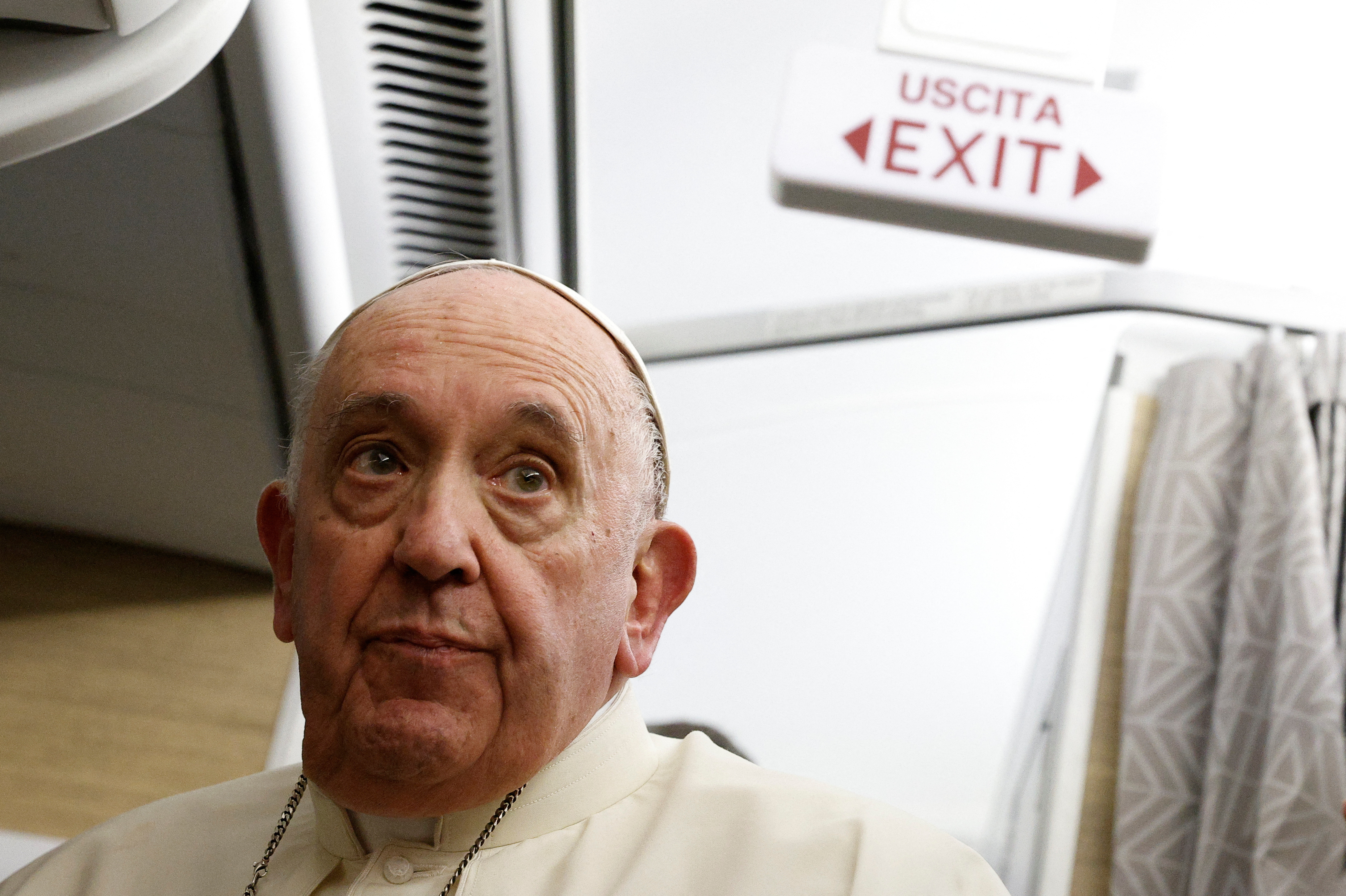 Pope Francis holds a news conference aboard the papal plane on his flight back after visiting Canada