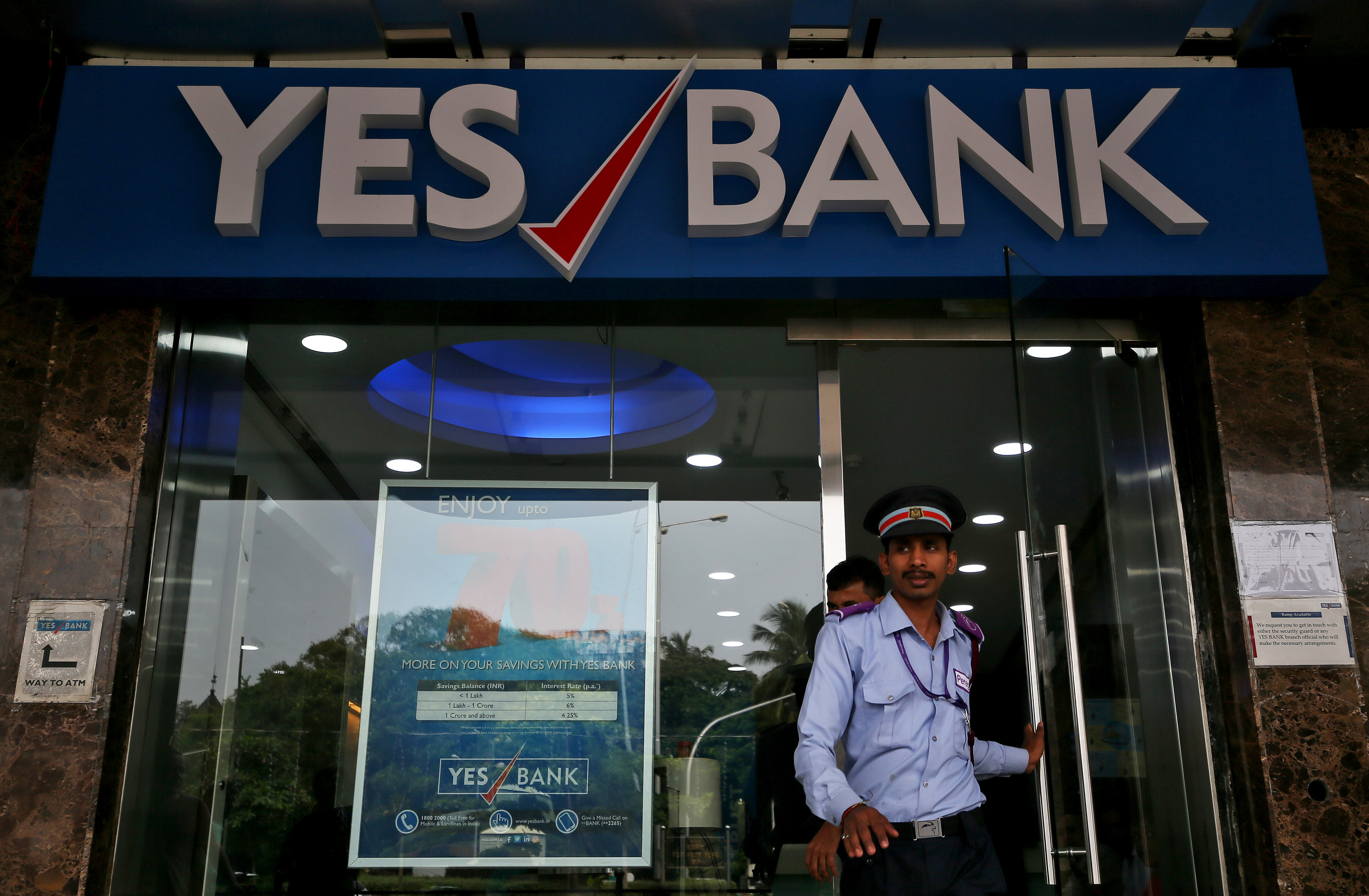 A watchman steps out of a Yes Bank branch in Mumbai