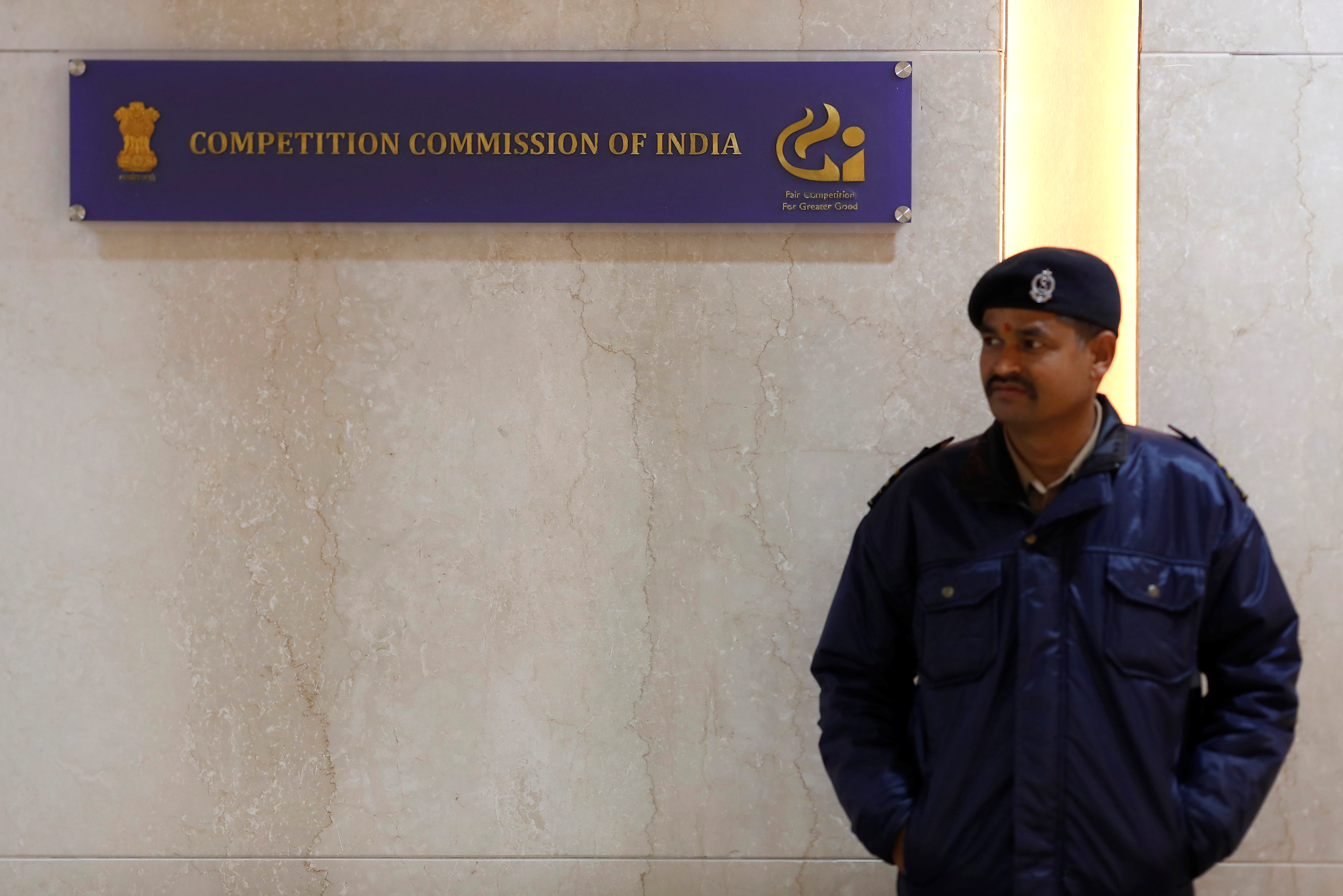 A security guard stands outside the Competition Commission of India (CCI) headquarters in New Delhi