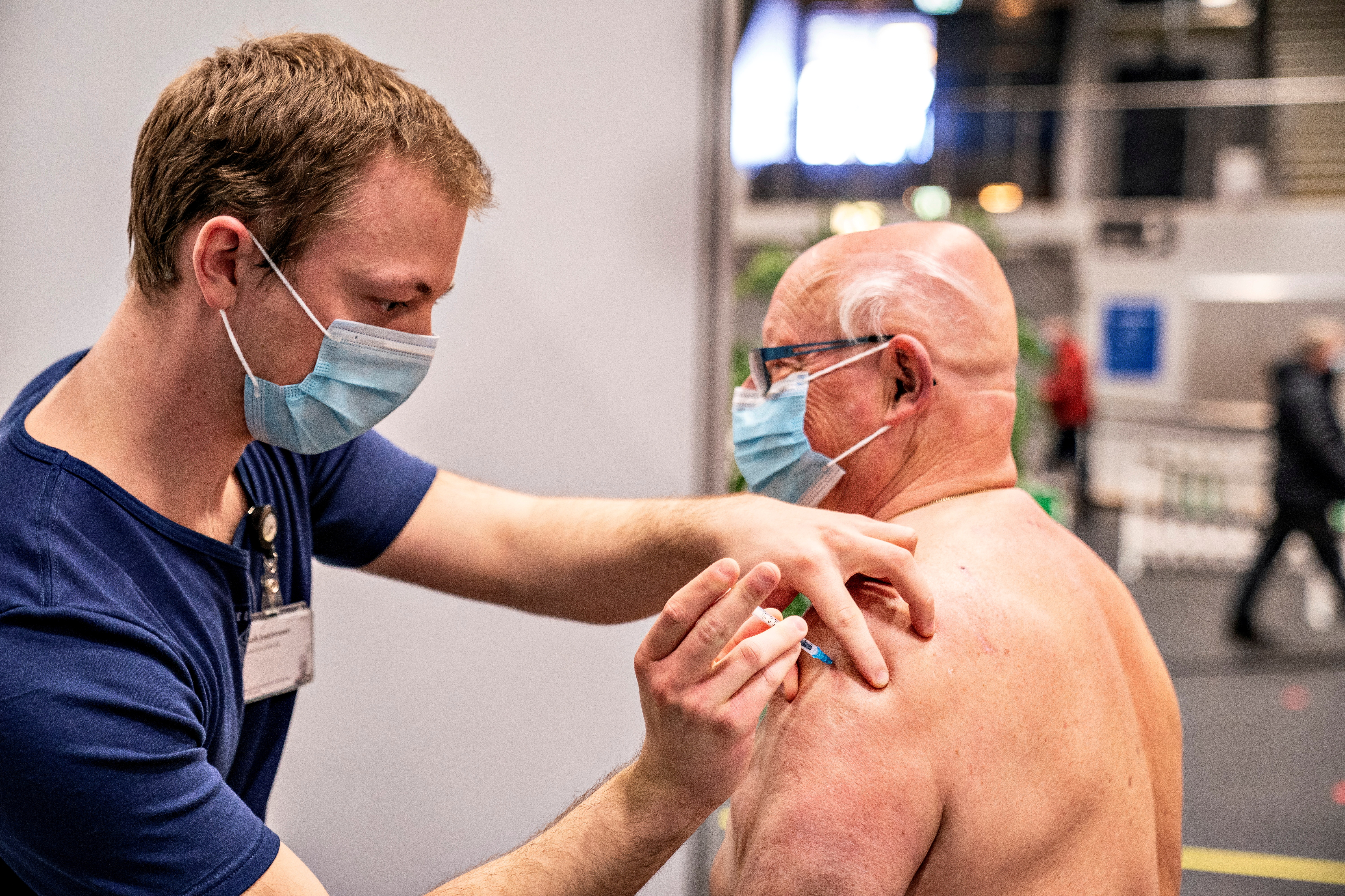 A medical worker vaccinates a man against the coronavirus disease (COVID-19) in Frederikshavn, Jutland, Denmark, April 12, 2021. Henning Bagger/ Ritzau Scanpix/via REUTERS