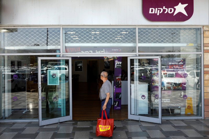 A man stands near the shop entrance of Israeli mobile phone operator, Cellcom, in Ashdod, south Israel
